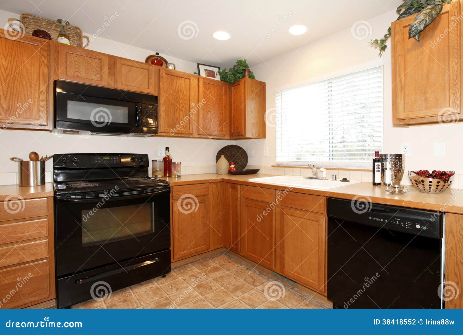 Brown Kitchen Cabinets With Black Appliances Stock Photo Image