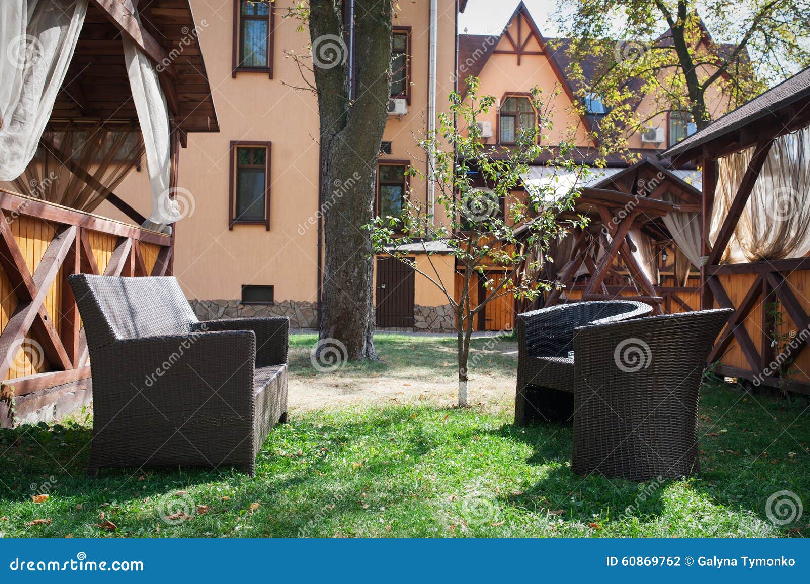 brown leather sofa and white fabric chairs