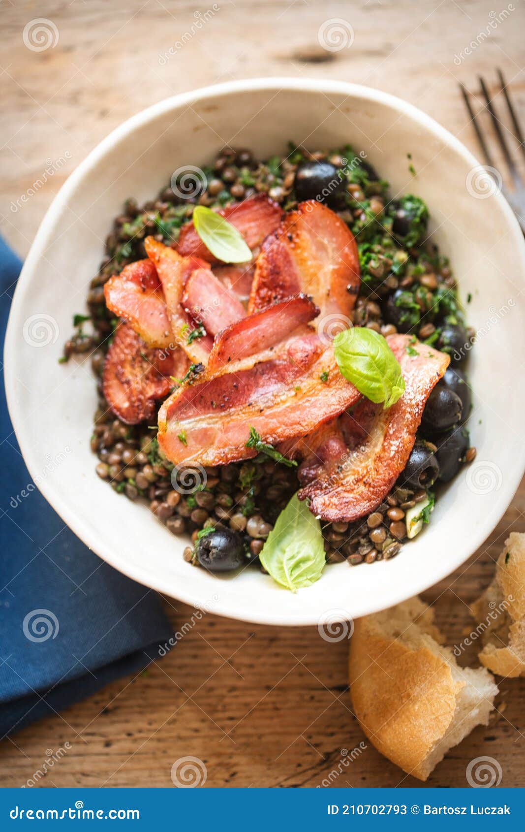 Brown Lentils with Spinach, Black Olives and Fried Bacon Stock Image