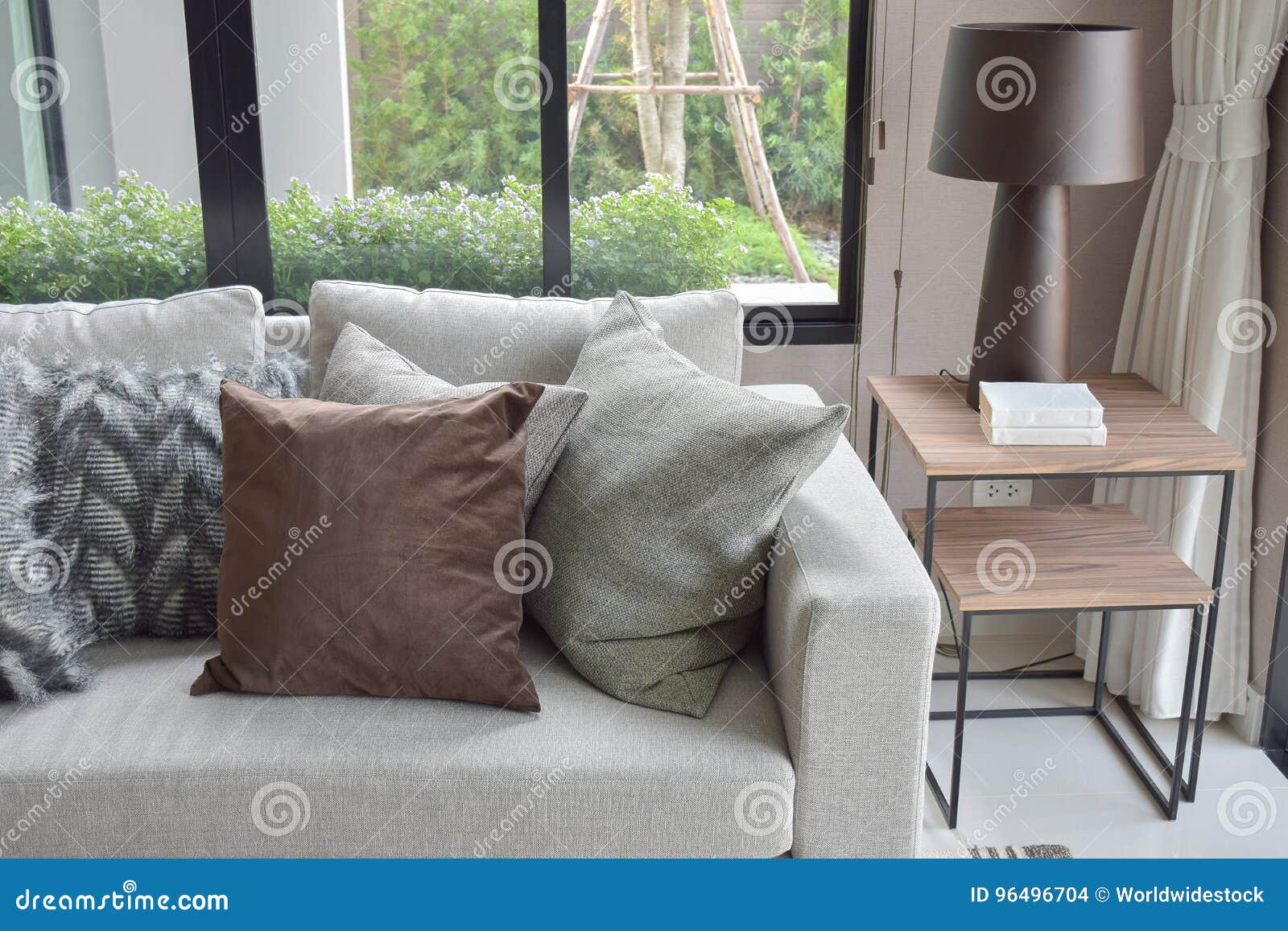 Brown and Light Gray Pillows Setting on Beige Couch in Living Room