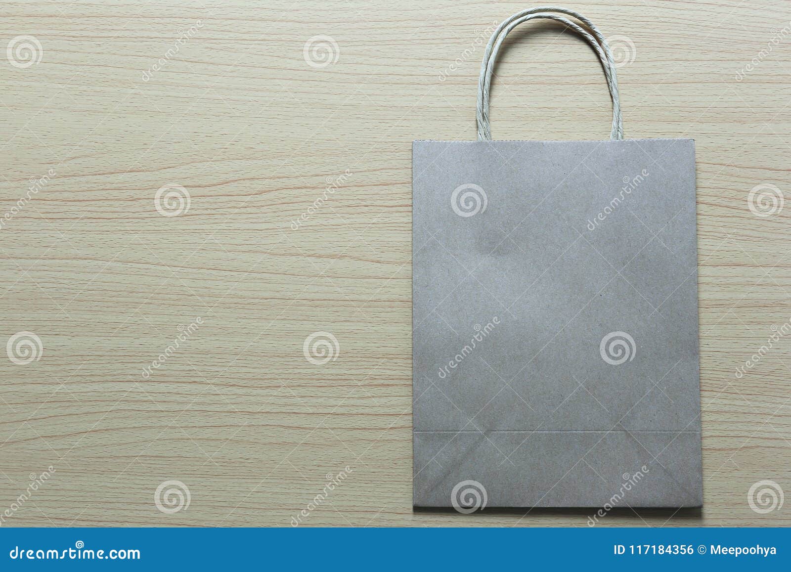Brown Paper Bag Is Placed On A Brown Wooden Floor Stock Photo