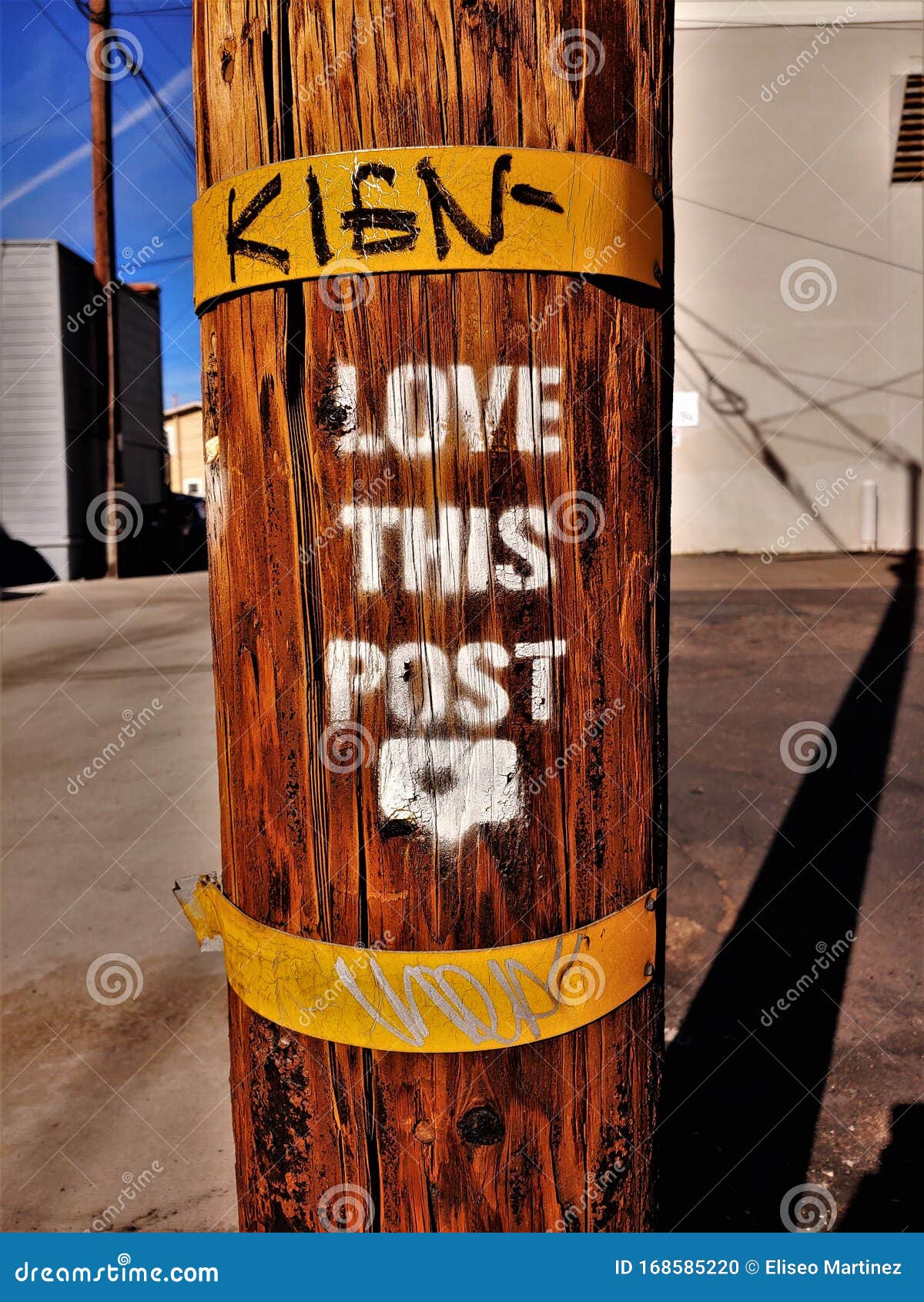 brown phone pole with love this post posted in alley