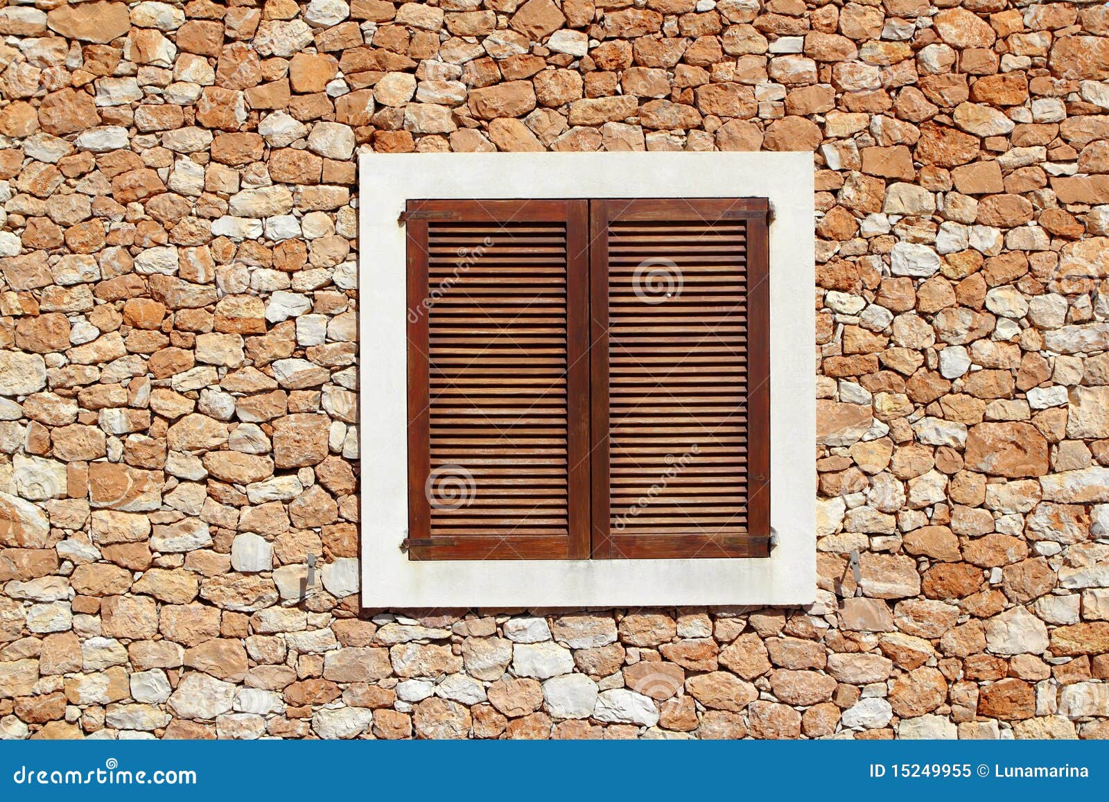 brown wooden window in masonry wall