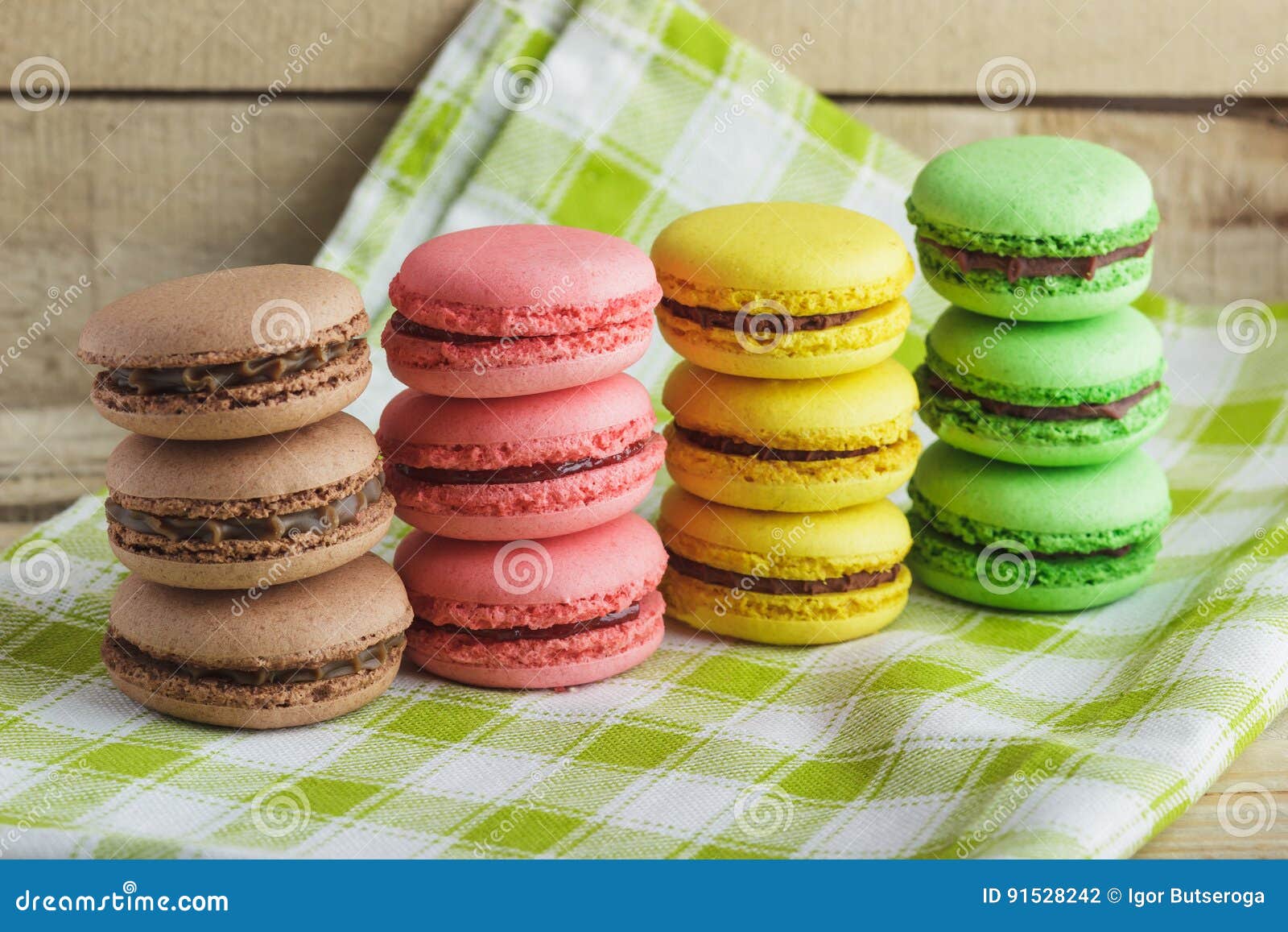 Brown, Yellow, Green and Pink Macarons on the Plaid Napkin Stock Photo ...