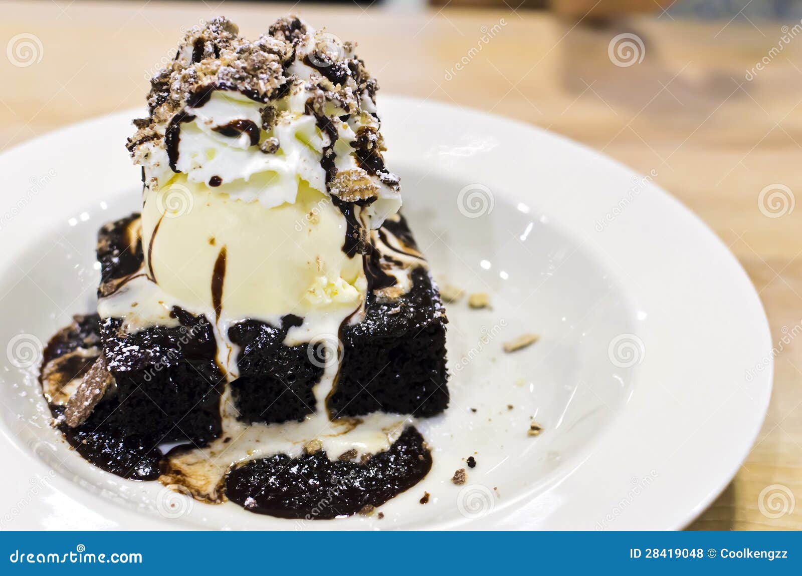 Brownie Dessert on a White Plate with Chocolate Syrup and Vanilla Ice