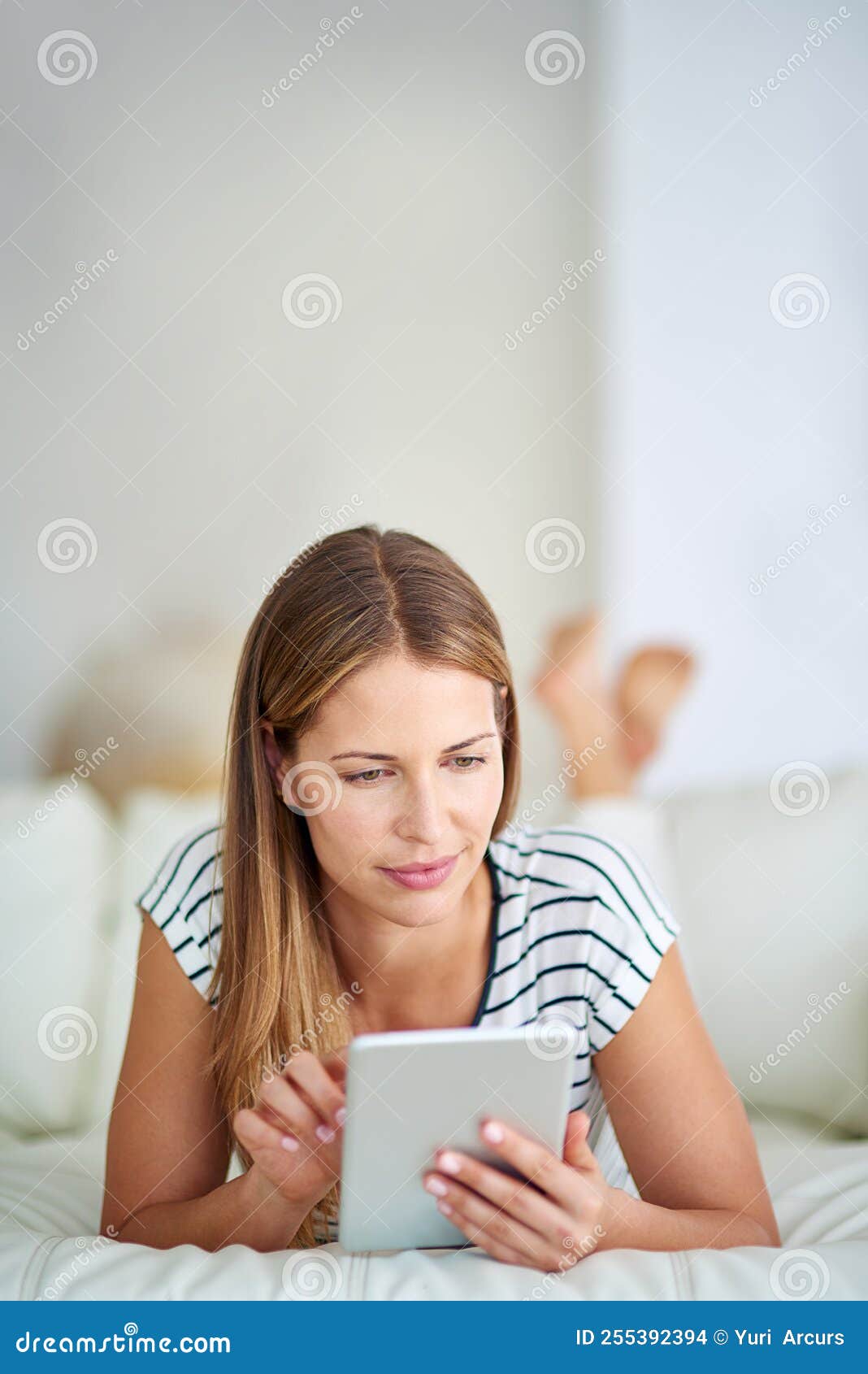 Browsing from a Comfy Couch. a Young Woman Browsing the at Home. Stock Photo Image of