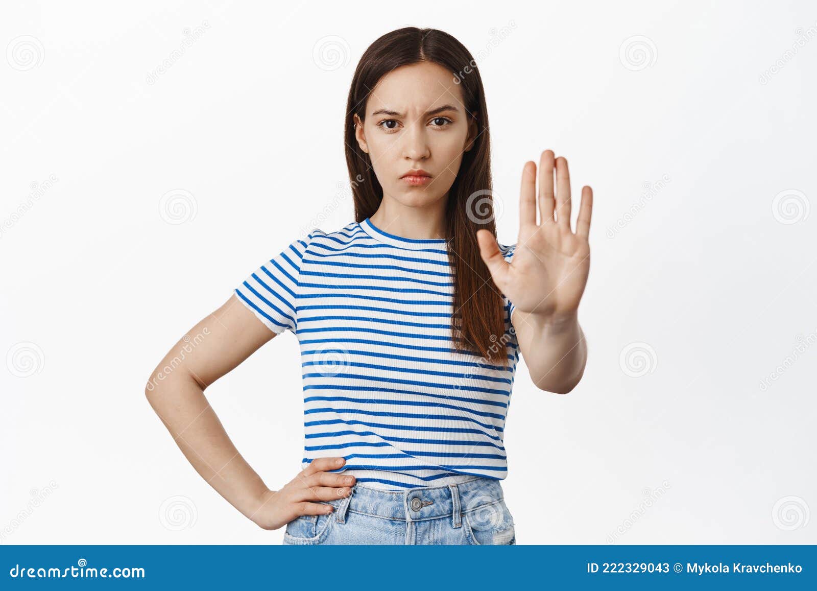 bruentte female extend palm, furrow eyebrows serious and confident, say no, stop right there, prohibit smth bad