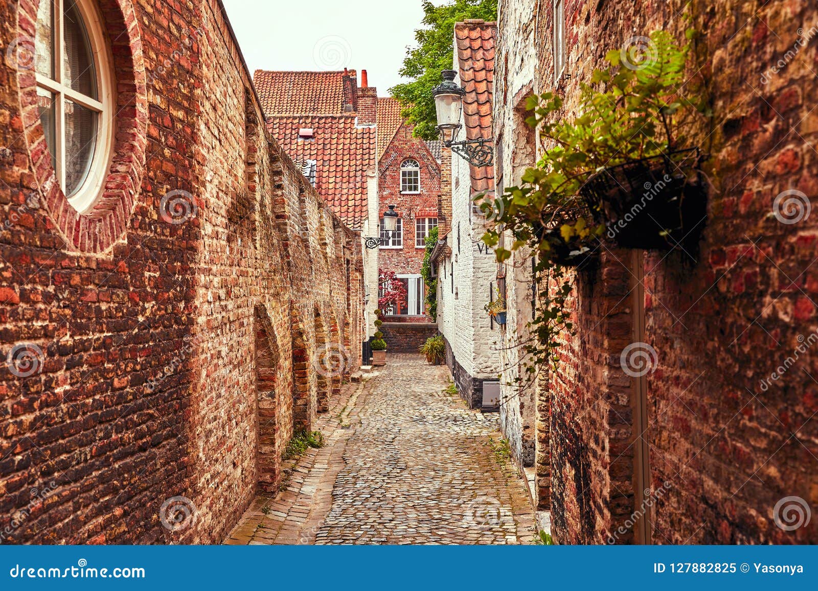 bruges belgium. antique brick walls along narrow