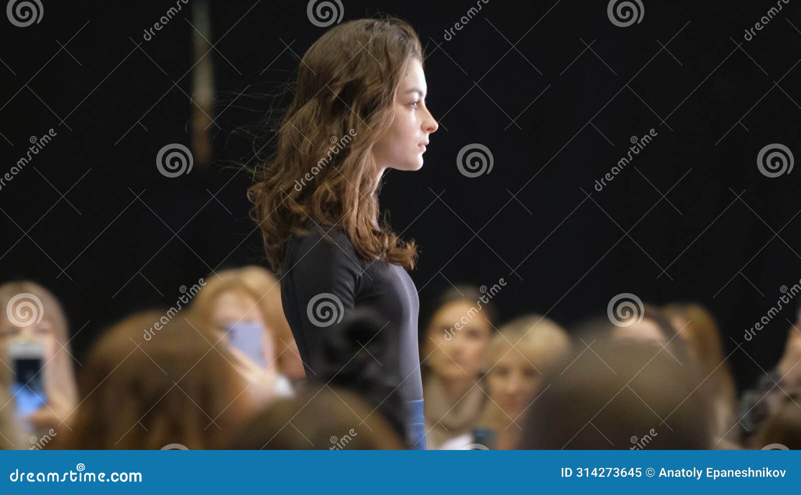 brunet female on podium catwalk during fashion show week. vogue runway defile.