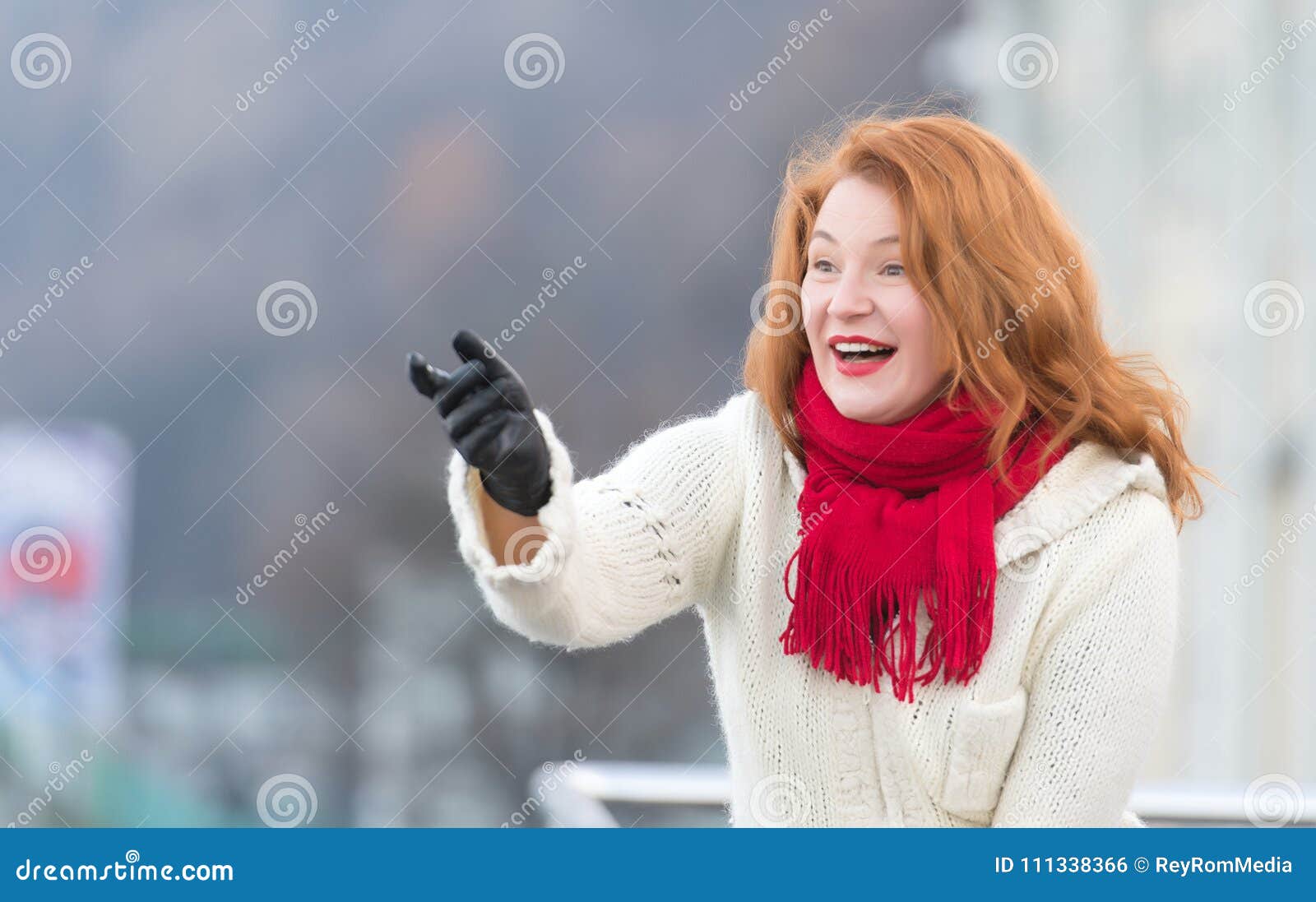brunette aged woman in white coat. rude attractive lady with red lips and red scurf. aged woman happy welcome on street.