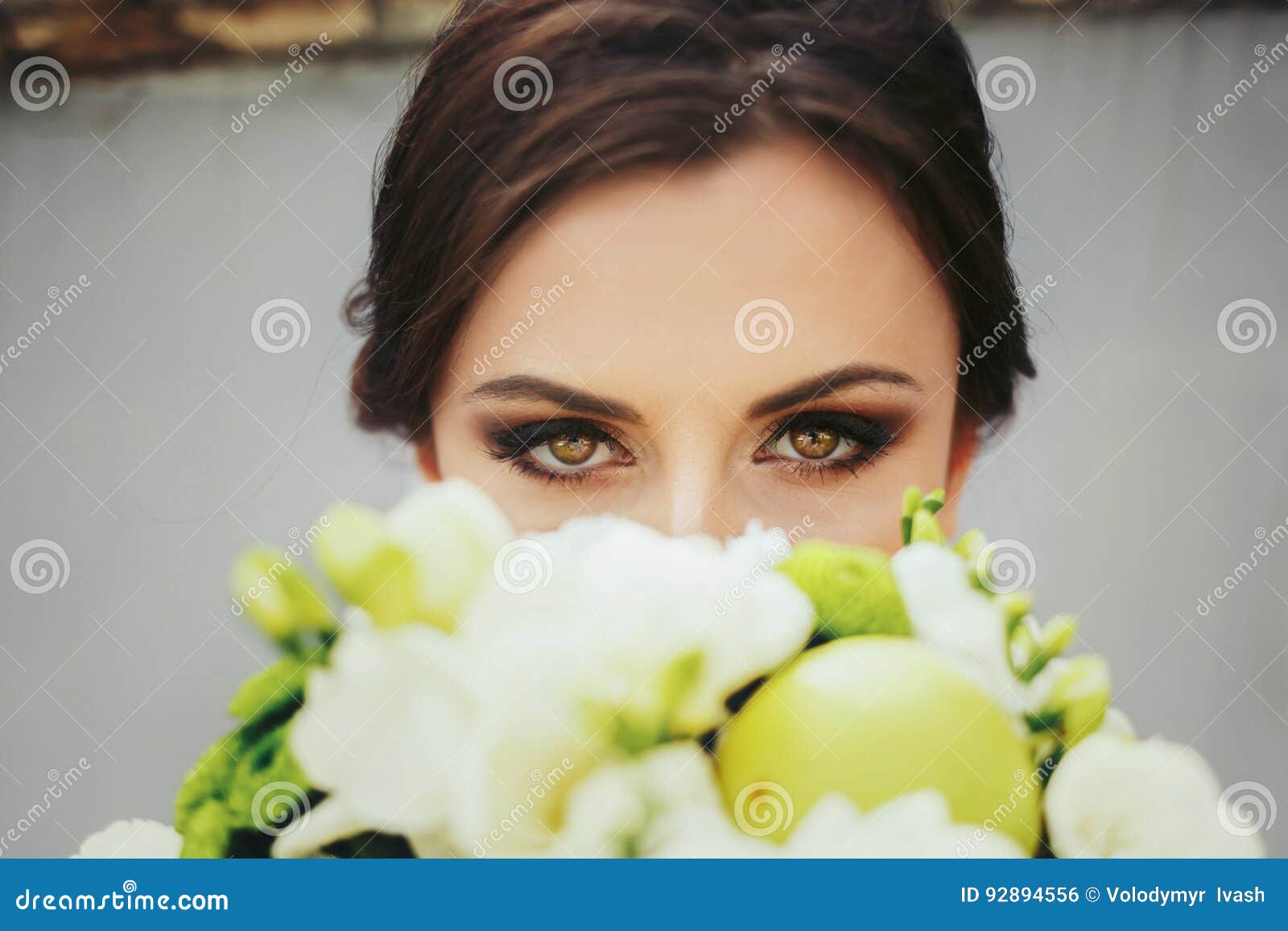 Brunette Bride with Magic Green Eyes Looks Over a Green Wedding Stock ...
