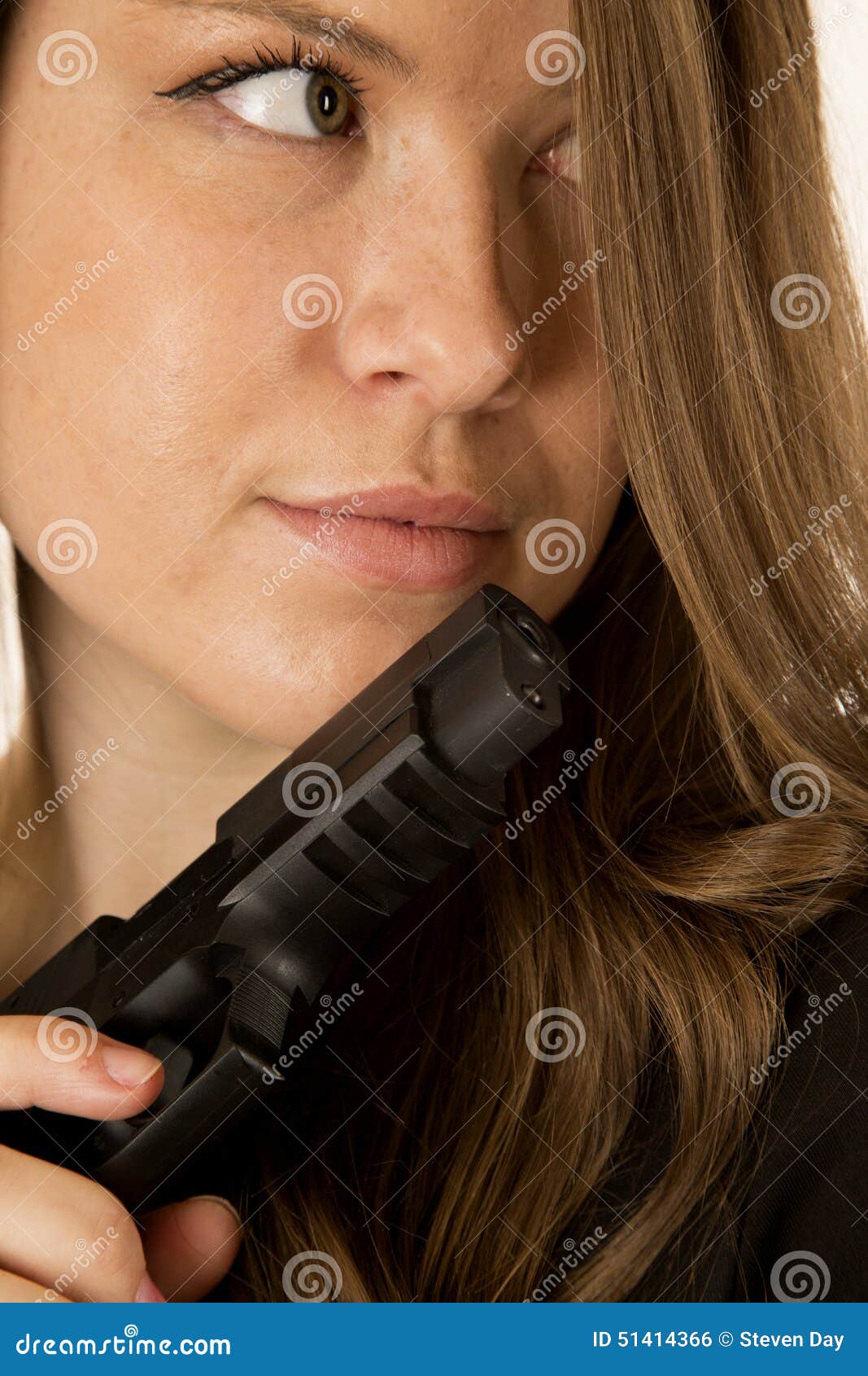 Female Model Glancing Sideways Holding a Black Pistol Stock