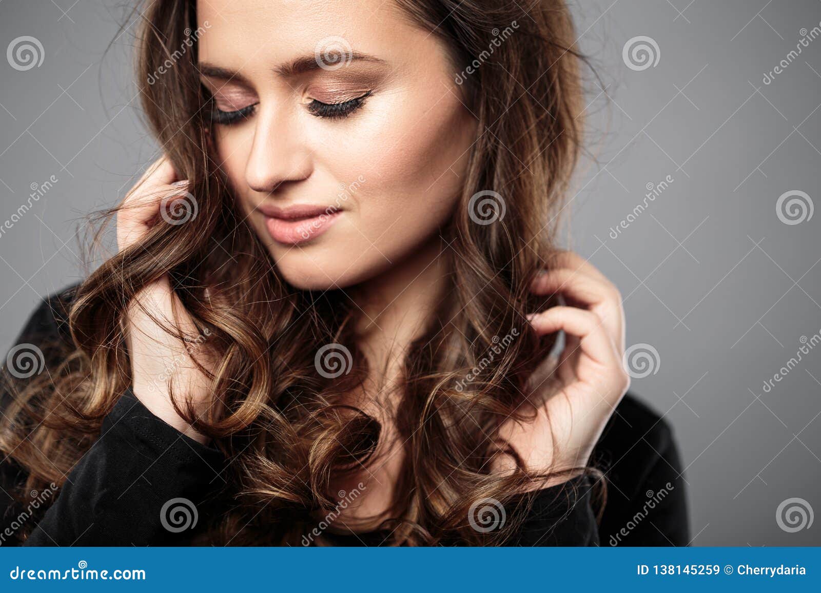 Brunette Girl With Healthy Curly Hair And Natural Make Up