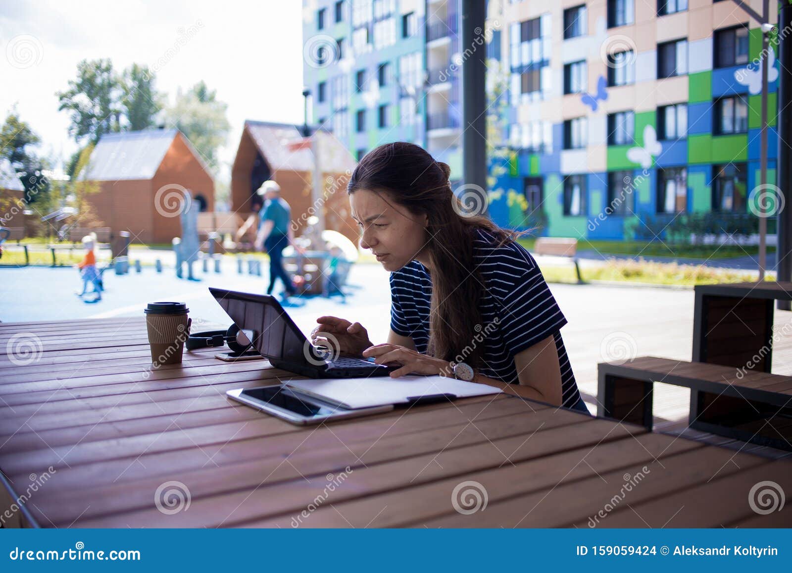 Brunette Girl Sitting Table in Front of a Laptop, Smiling, Looking at ...