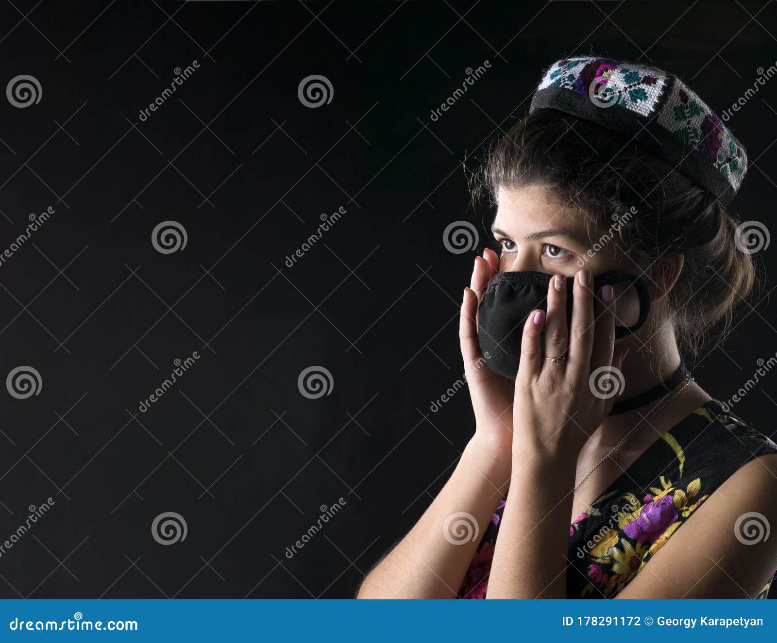 A Brunette Girl Is Wearing A Black Medical Mask On Her Face She Is Wearing A National Costume