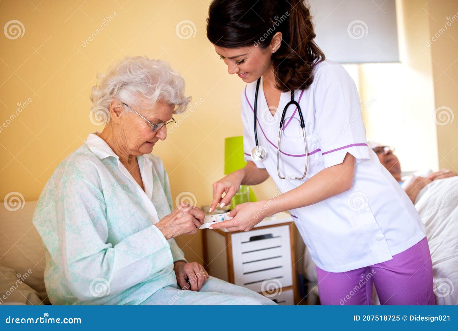 brunette lady doctor and her nursing home elder woman patient having polite conversation