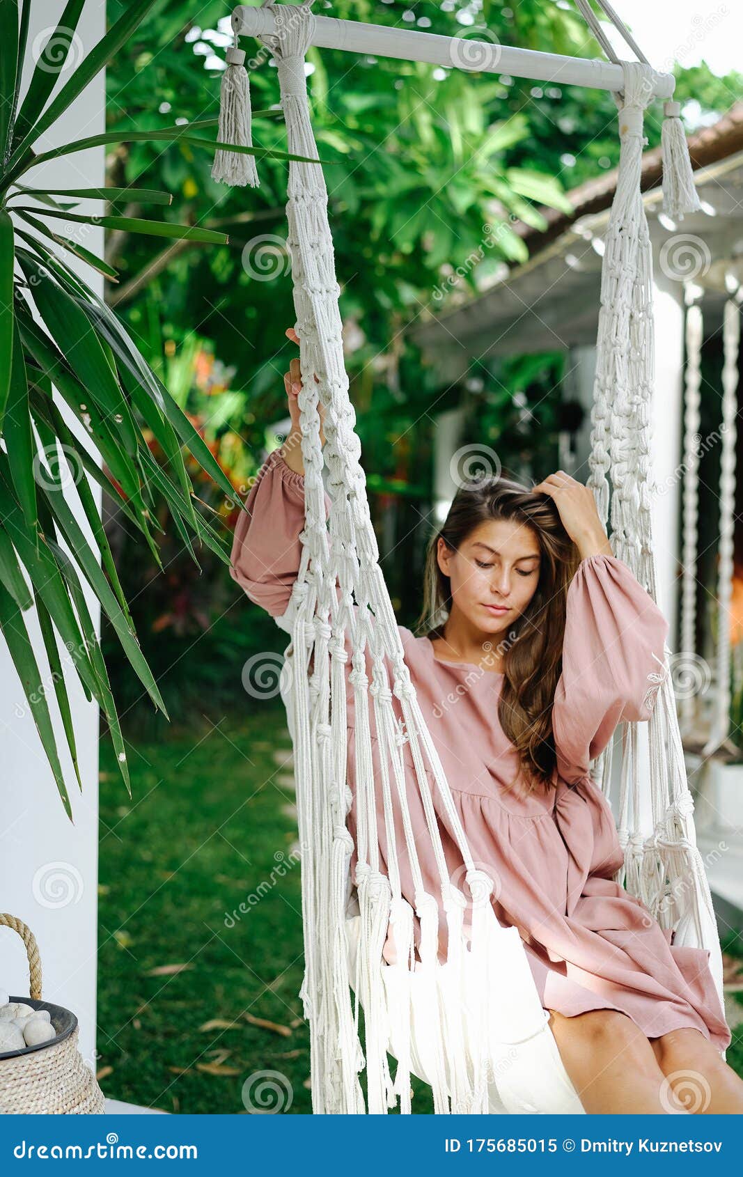 Brunette Relaxing In A Hammock Outside Her Resort House Stock Image