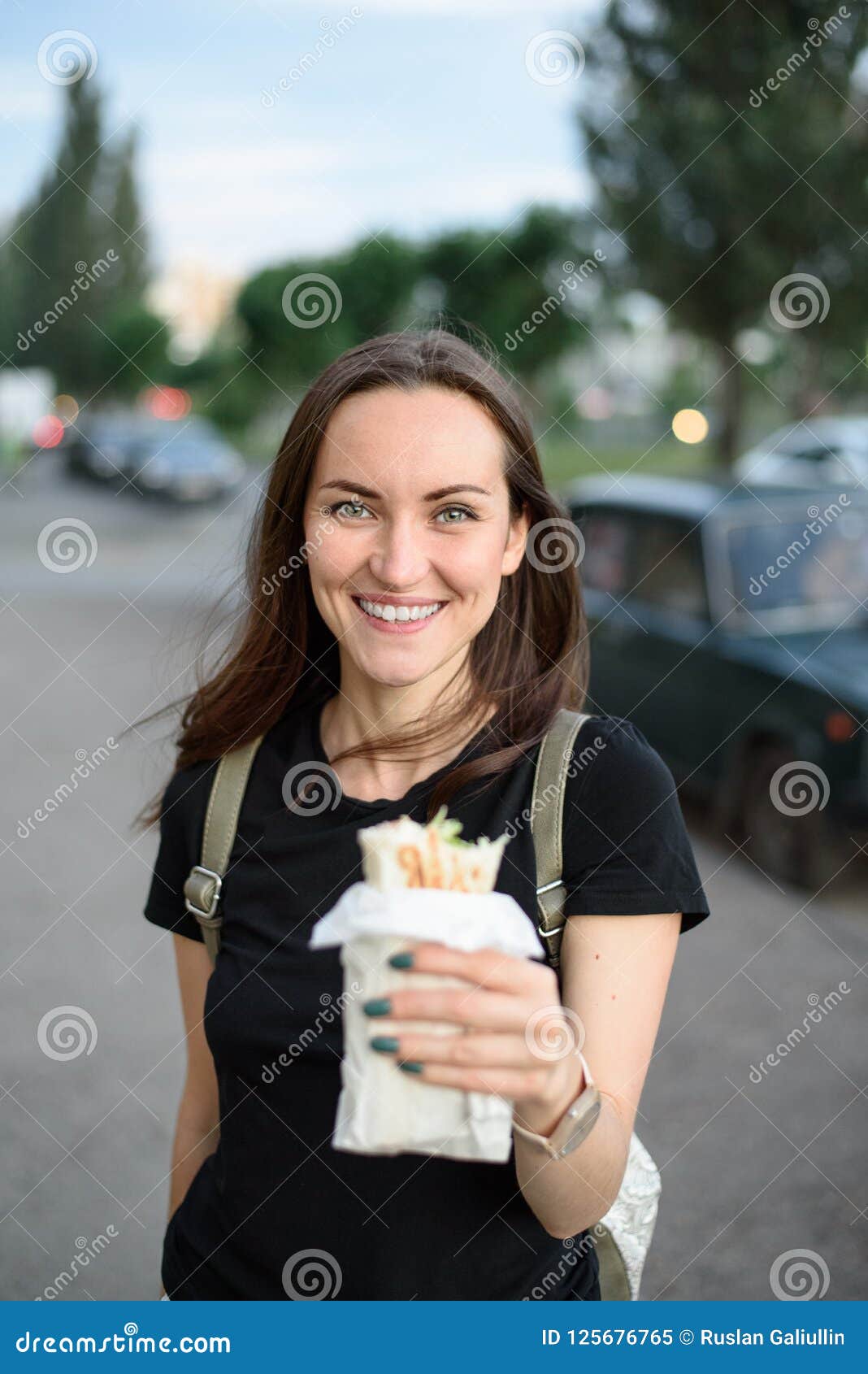 The Brunette Smiles Widely Holds Fast Food In Her Hand Stock Image Image Of Sandwich Doner