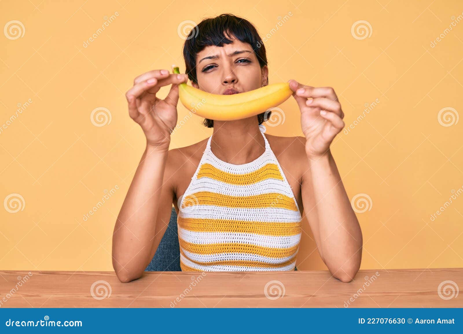 Brunette Teenager Girl Holding Banana Like Funny Smile Looking at the Camera  Blowing a Kiss Being Lovely and Stock Photo - Image of lovely, cute:  227076630