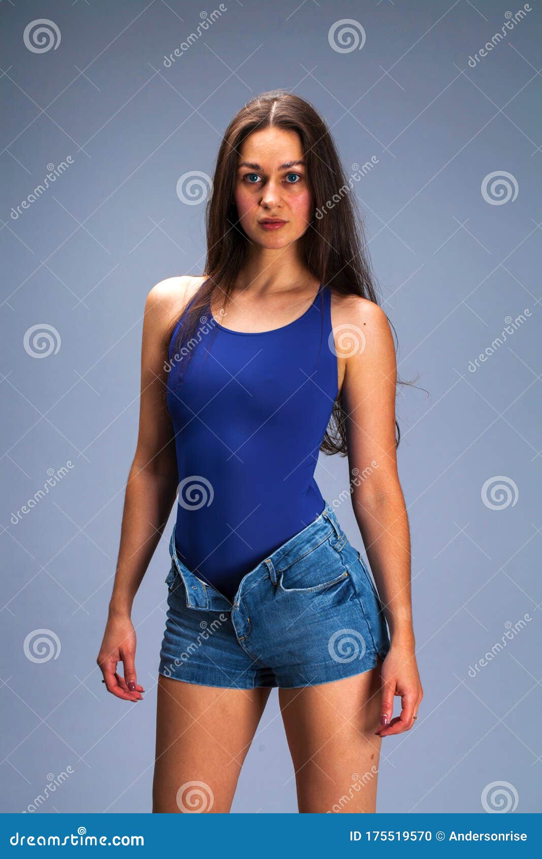 Brunette Woman in Blue Bathing Suit and Jeans Shorts Posing in the ...