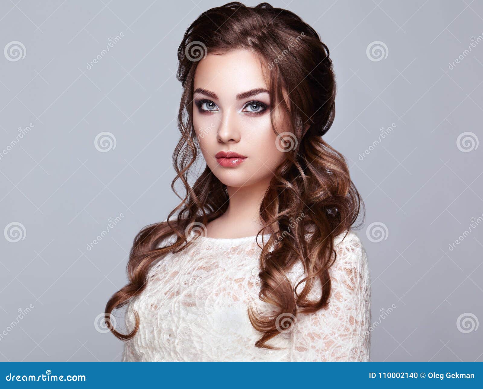 brunette woman with long and shiny curly hair