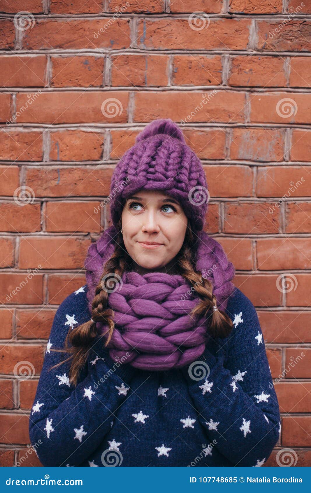 brunette woman in purple knitted hat and scarf