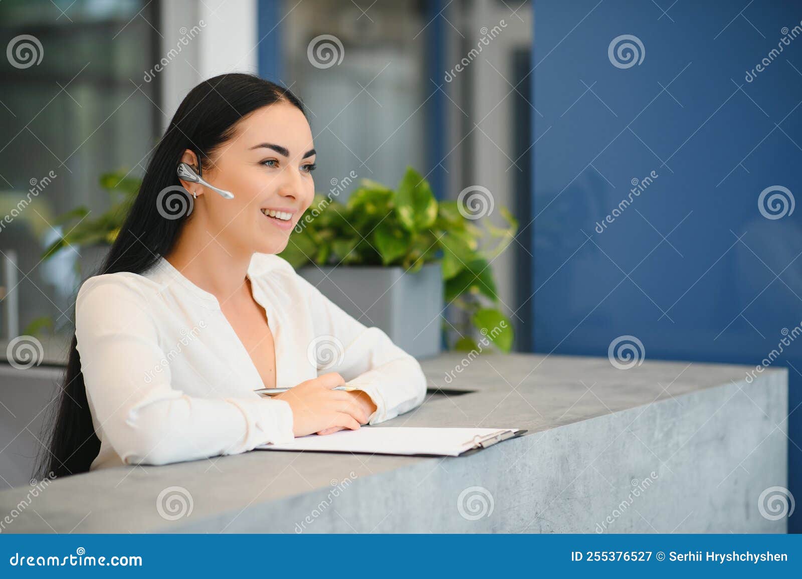 Brunette Woman Receptionist Working in Reception of the Beauty Salon Brunette Woman Receptionist Working in Reception of the Beauty Salon