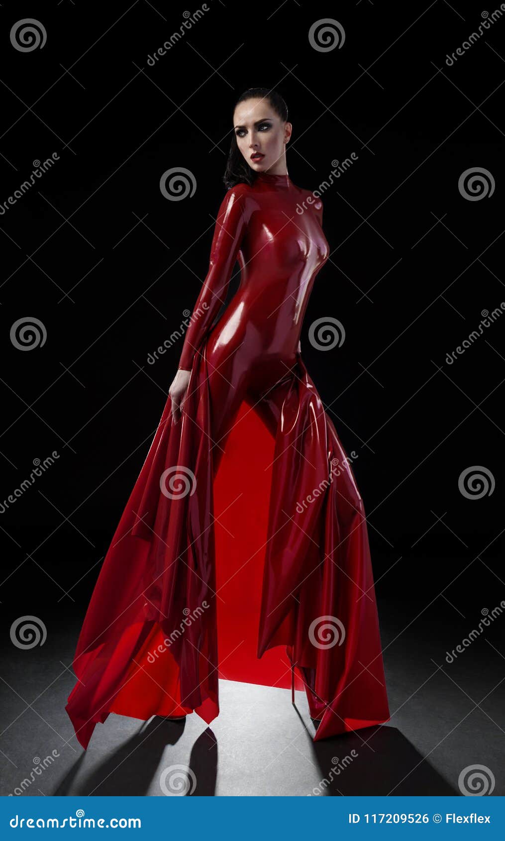 Brunette Woman in Red Latex Slim Suit ...