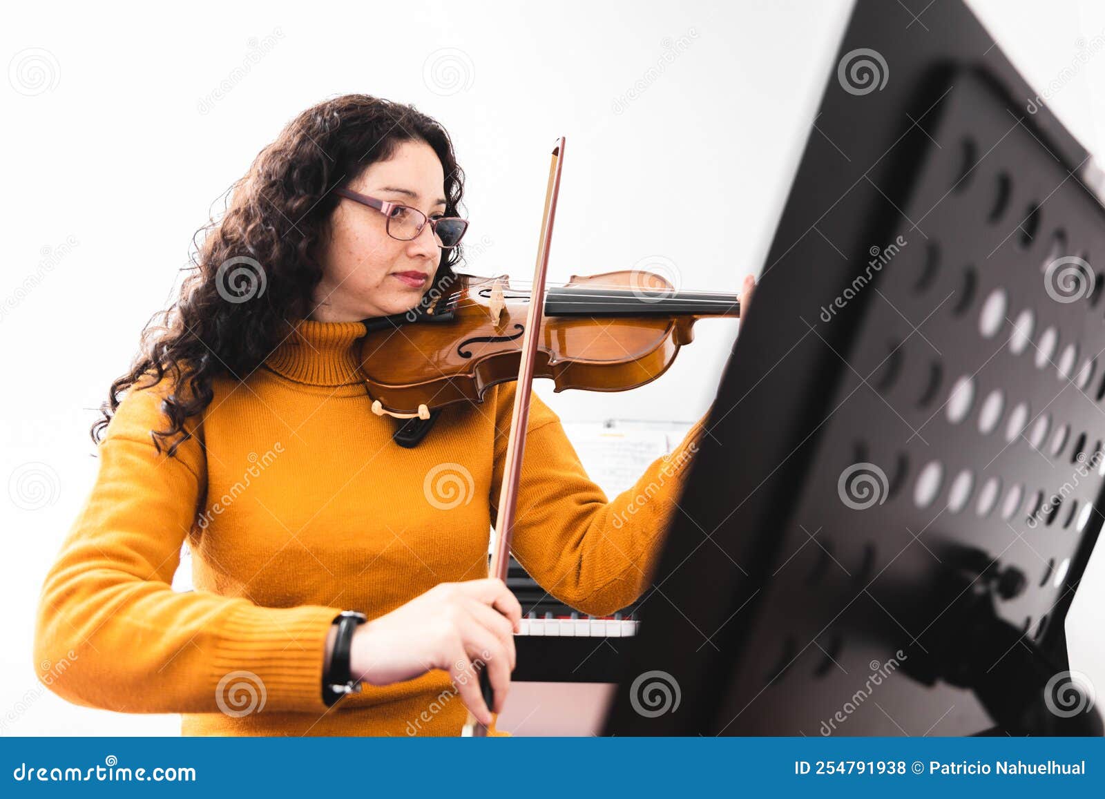 Brunette Woman Wearing a Yellow Sweater, and Playing Violin by