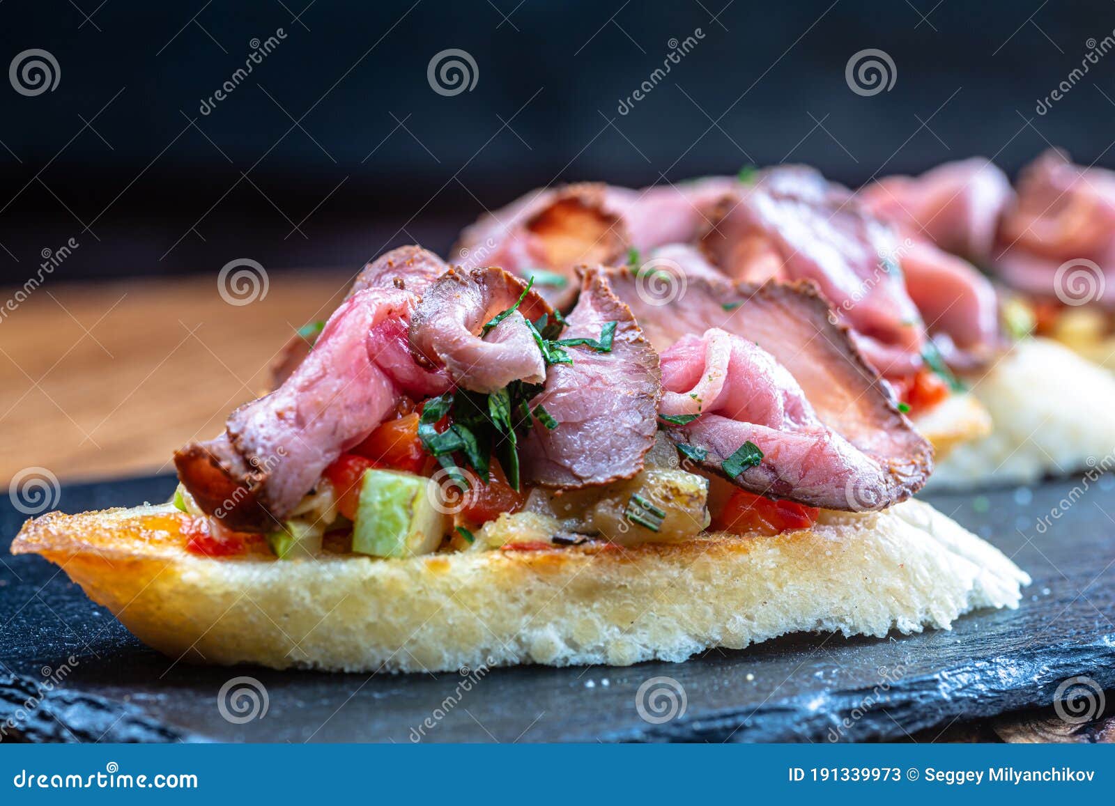 Bruschetta with Ham or Roast Beef is on a Slate Plate Stock Image