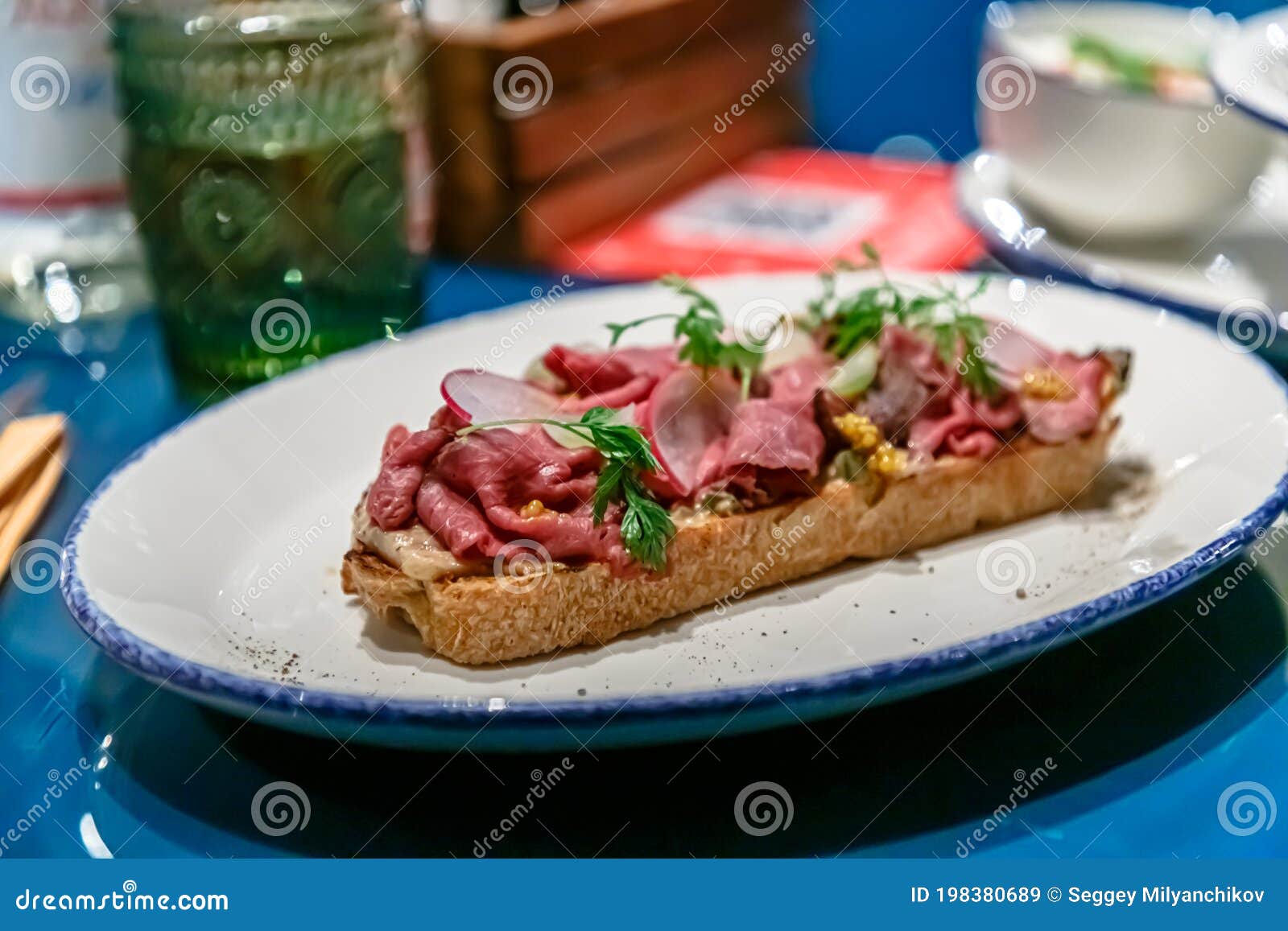 Bruschetta with Roast Beef, Radishes and Vegetables on a Plate Stock