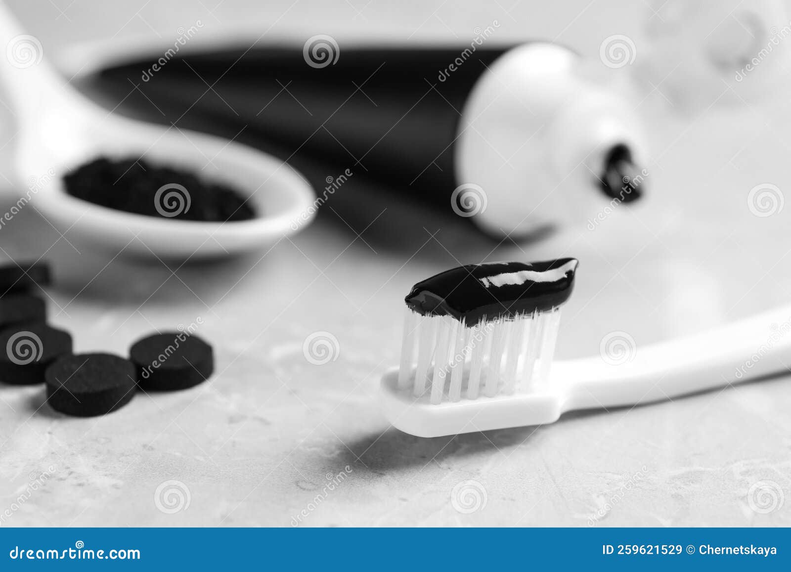 Brush with Charcoal Toothpaste on Light Grey Table, Closeup Stock Image