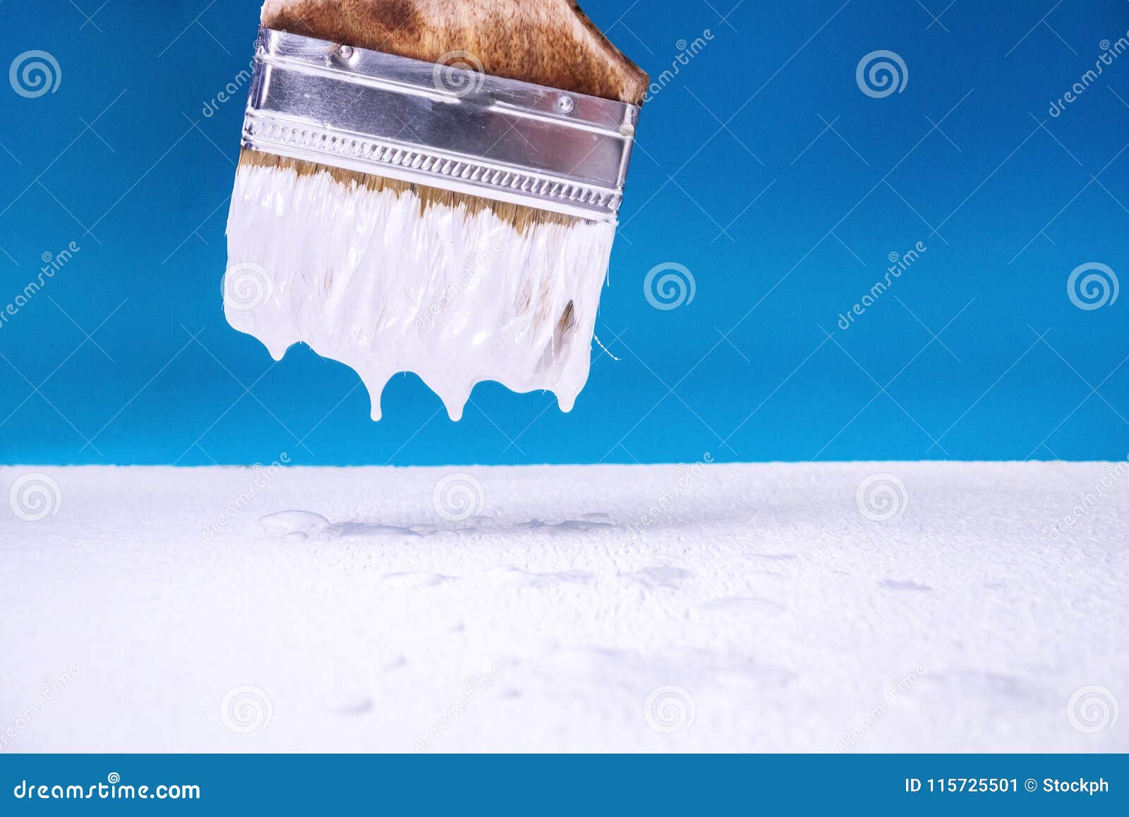 With a Brush Dripping White Paint on the Surface Does the Painting