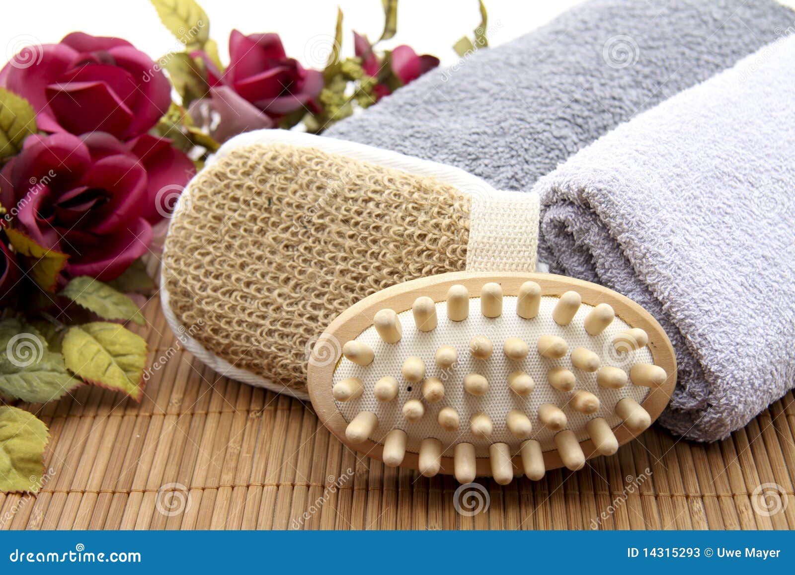 Massage brush with sponge and towel on mat