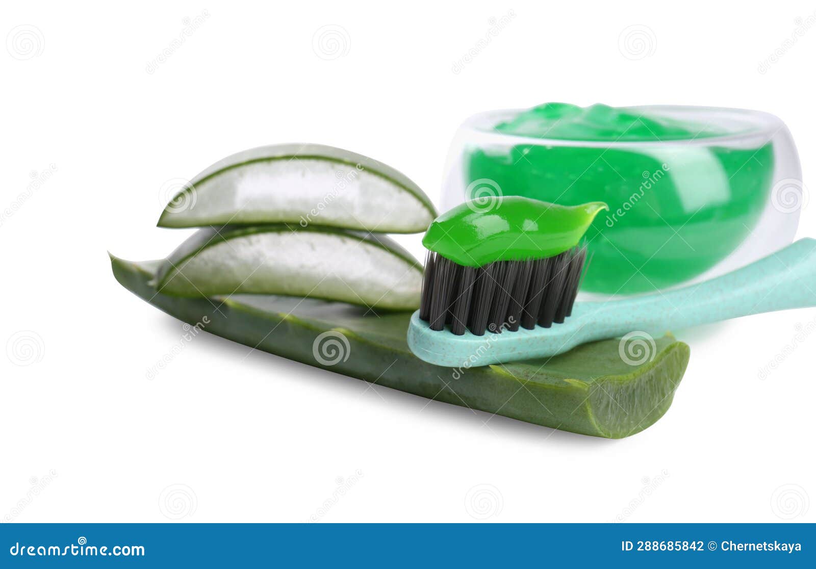 Brush with Toothpaste and Green Aloe Leaves on White Background Stock