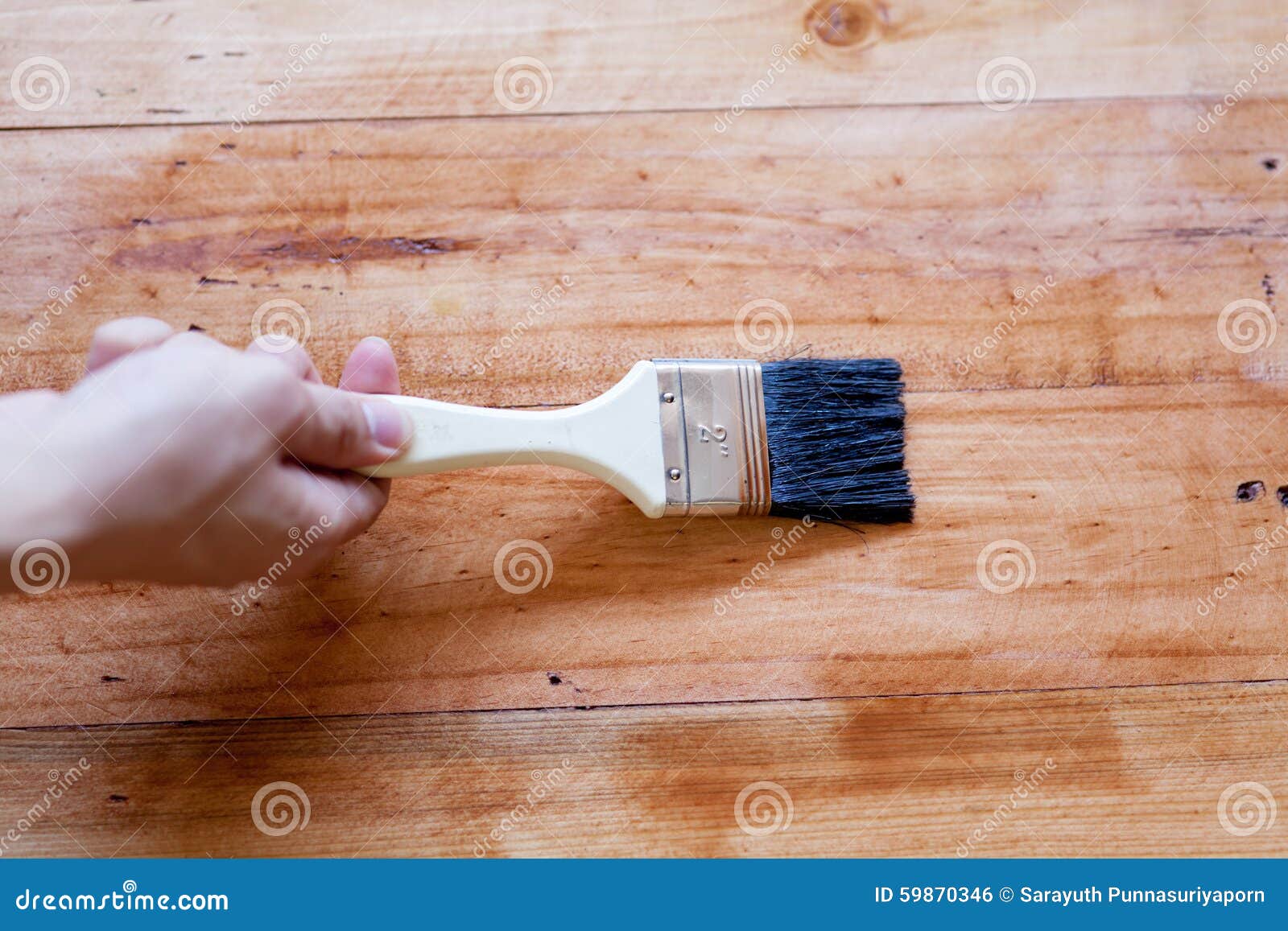 cleaning a paintbrush covered in wood stain with turpentine cleaning a paintbrush covered in wood stain with turpentine