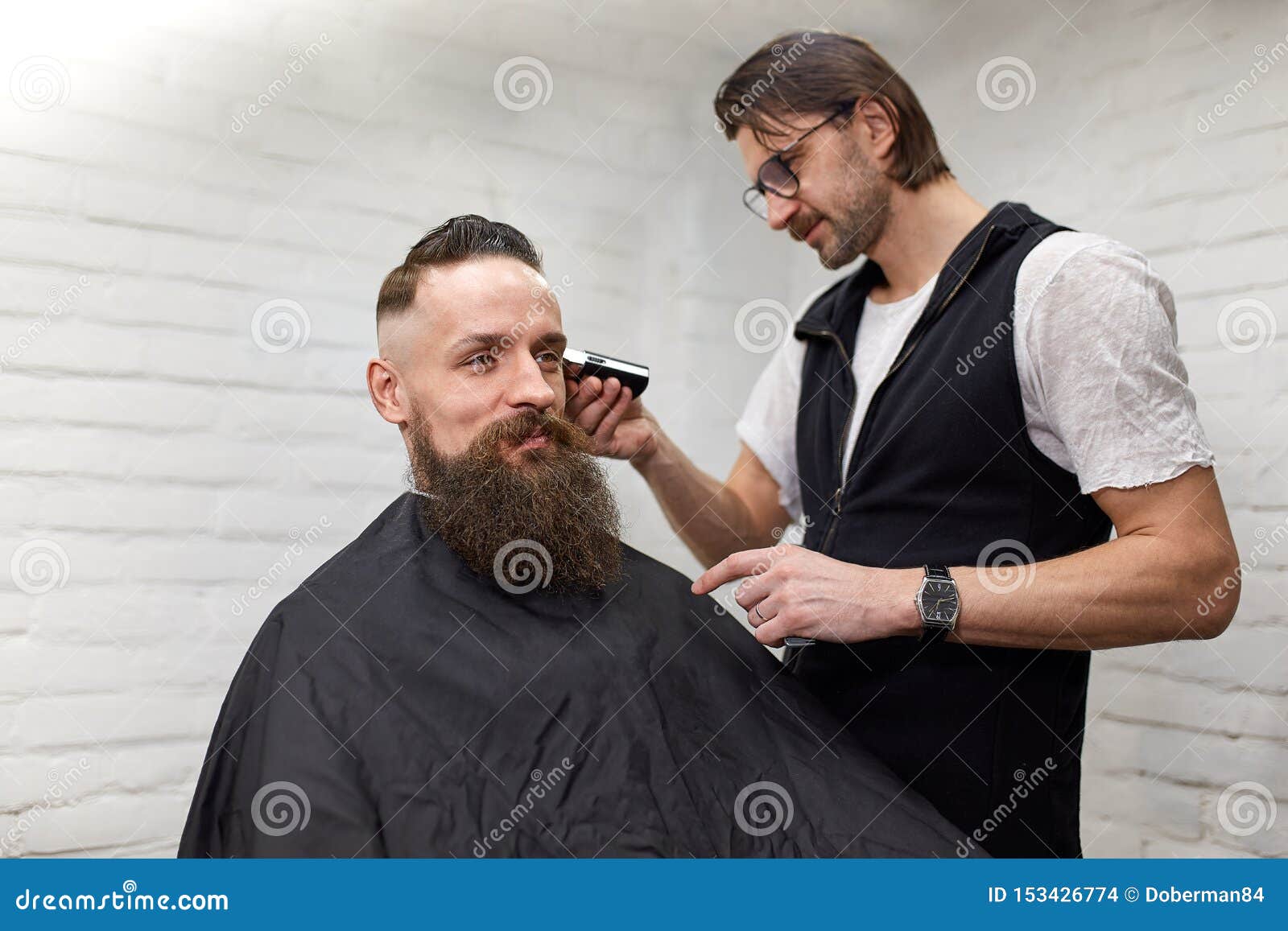 Brutal Guy in Modern Barber Shop. Hairdresser Makes Hairstyle a Man ...
