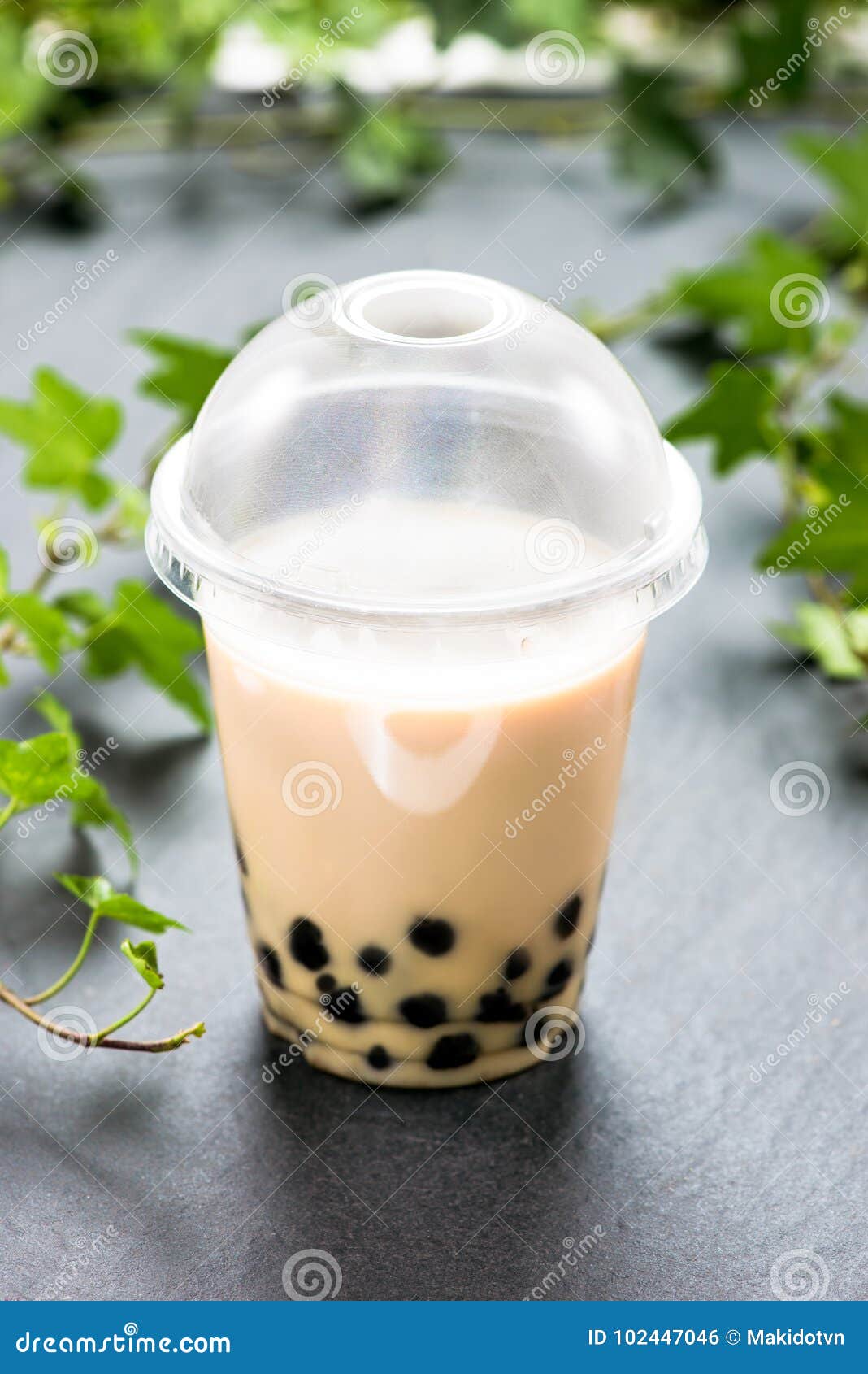 Bubble Boba Tea with Milk and Tapioca Pearls in Plastic Cup Stock Photo