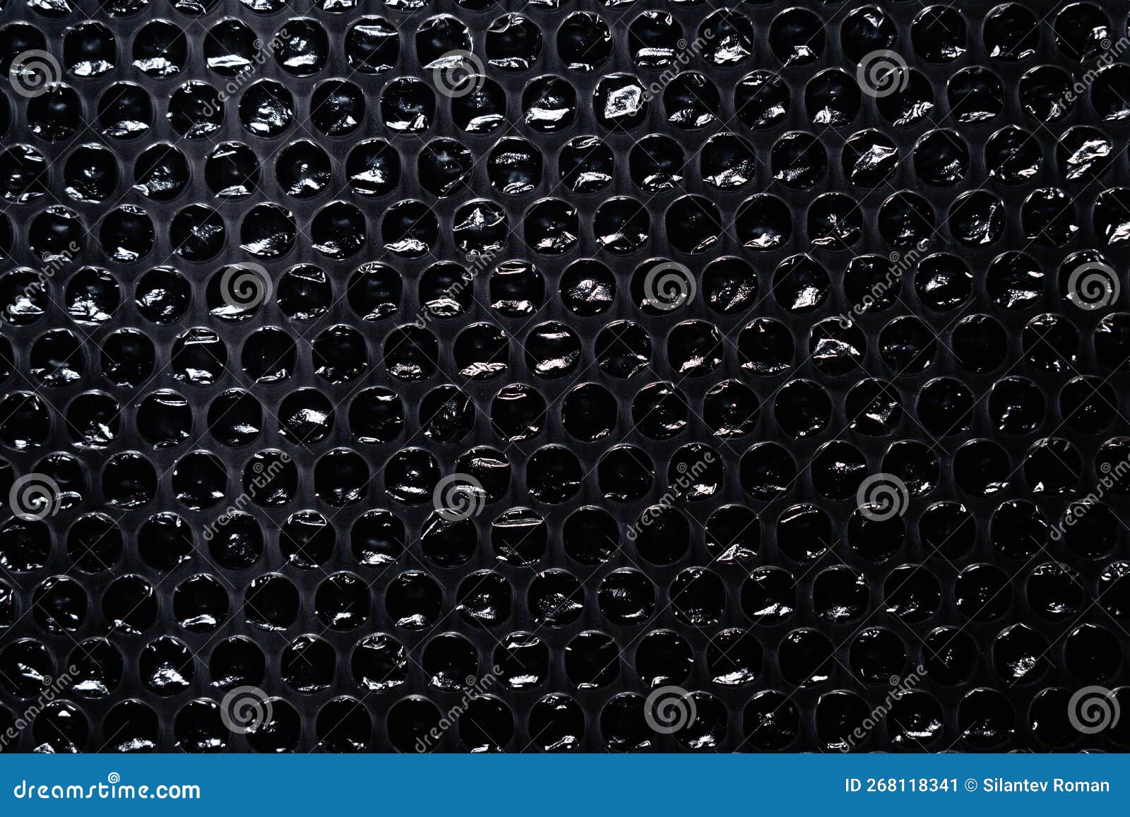 Plastic Packaging Material with Air Bubbles on Black Background Stock