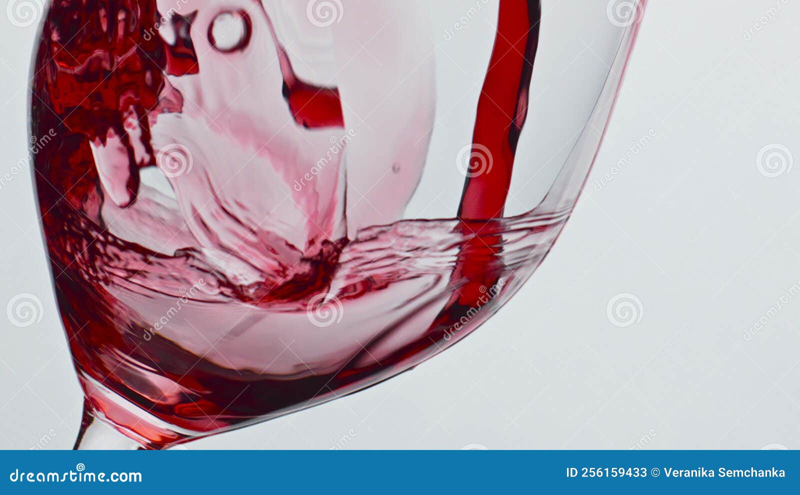 bubbled red wine beverage closeup. fresh alcoholic liquid swashing wineglass