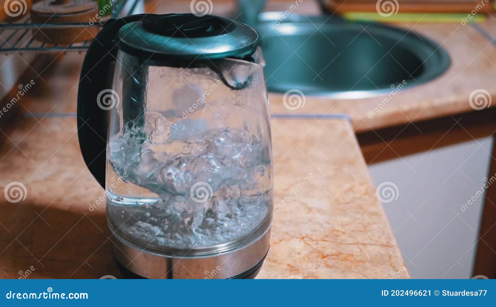 https://thumbs.dreamstime.com/z/bubbles-water-boiling-inside-glass-electric-kettle-backdrop-kitchen-air-bubbles-rising-slow-motion-water-water-boils-202496621.jpg