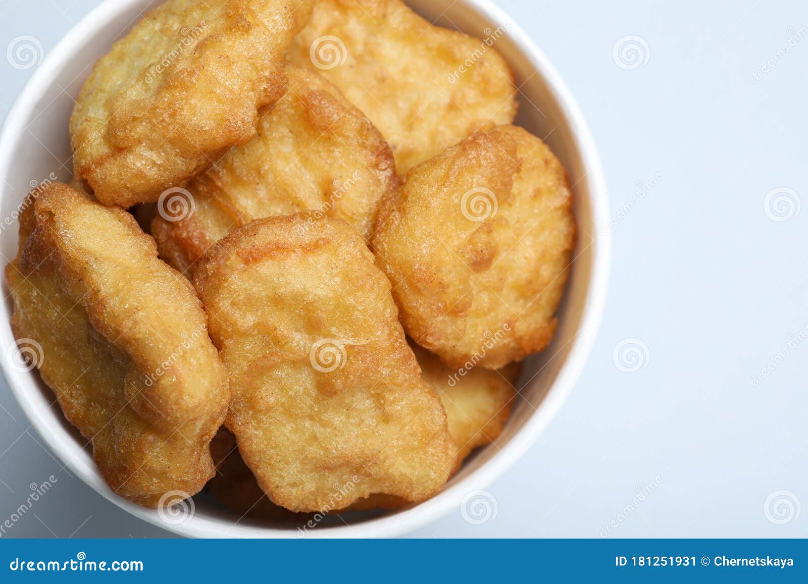 Bucket with Delicious Chicken Nuggets on Background, Closeup Stock