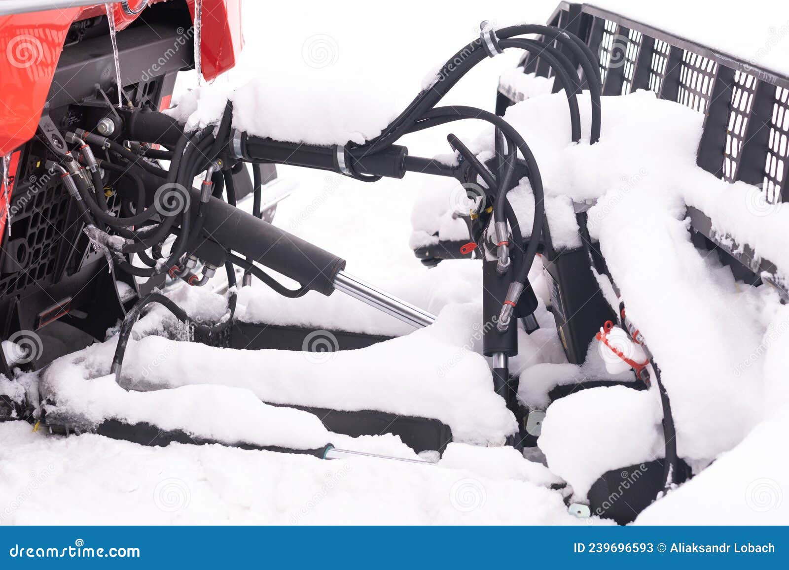 The Bucket of a Snowplow on Tracks, Standing in the Forest in Winter