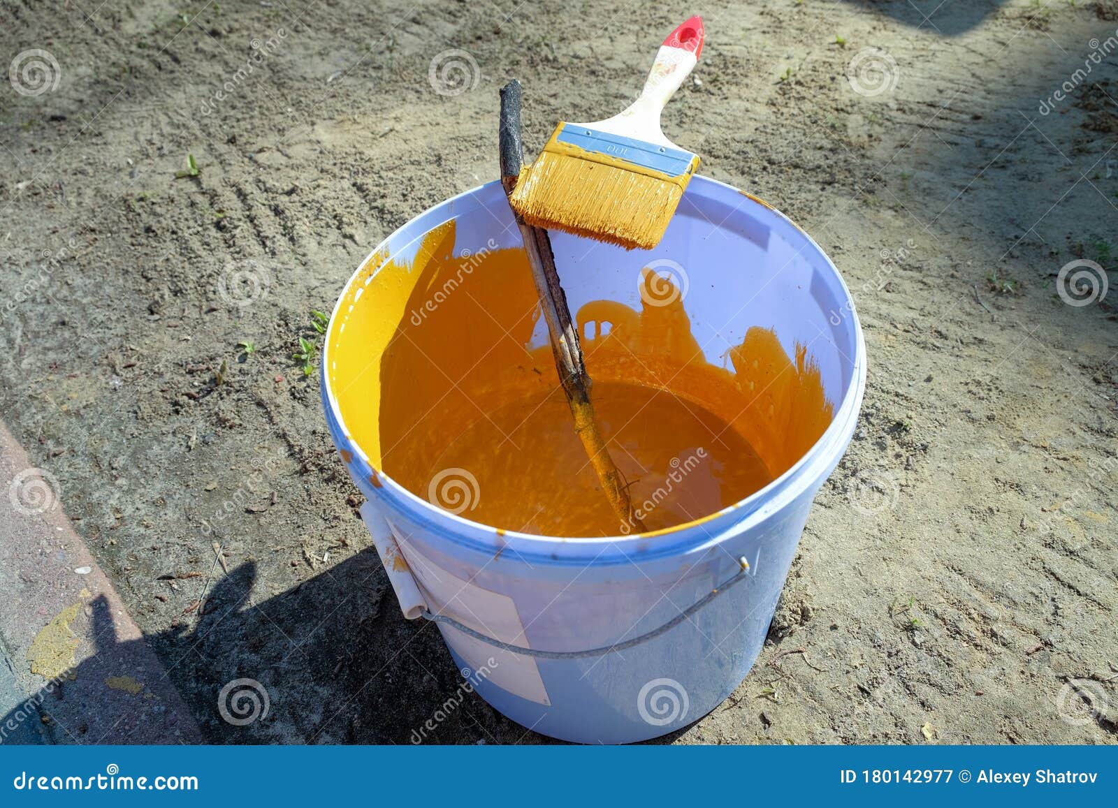 A Bucket of Yellow Paint and a Paintbrush Stock Image Image of liquid