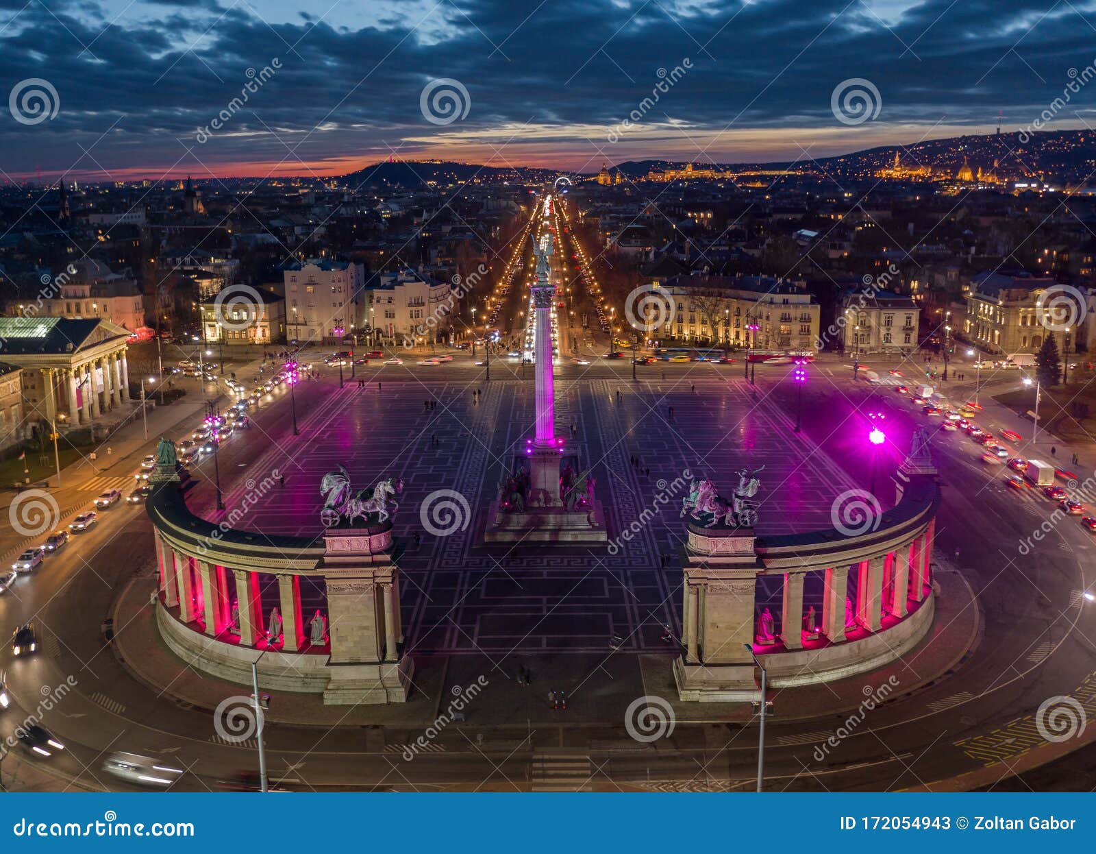 budapest, hungary - aerial drone view of the famous heroes` square hosok tere lit up in unique purple and pink color by night