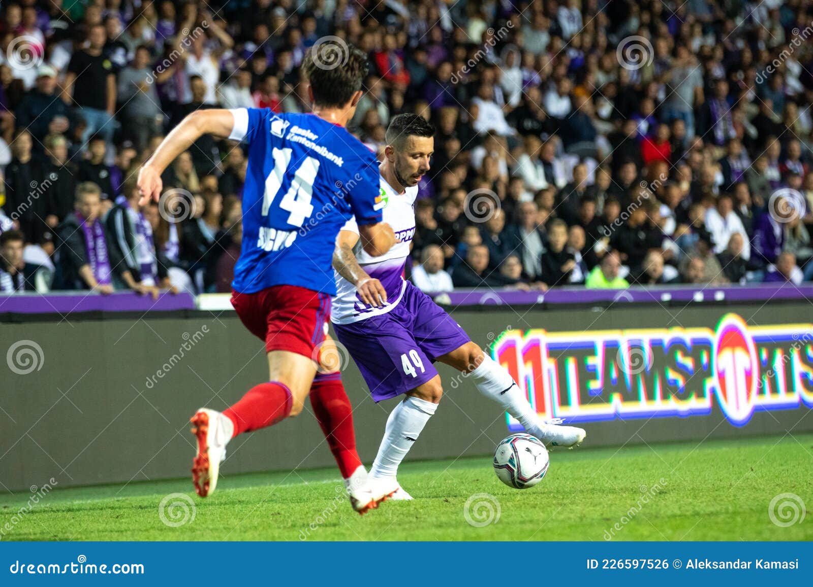 Branko Pauljevic of Ujpest FC competes for the ball with Tokmac