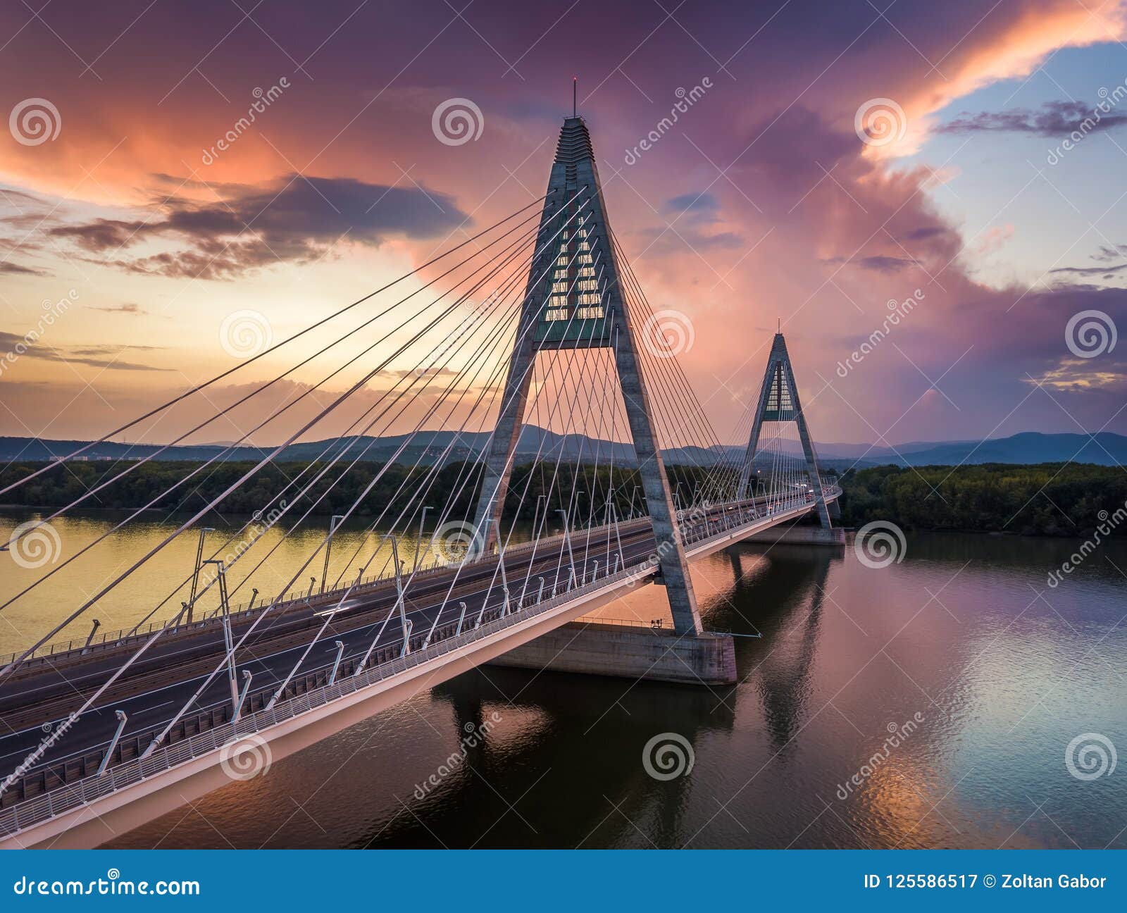 budapest, hungary - megyeri bridge over river danube at sunset with beautiful dramatic clouds