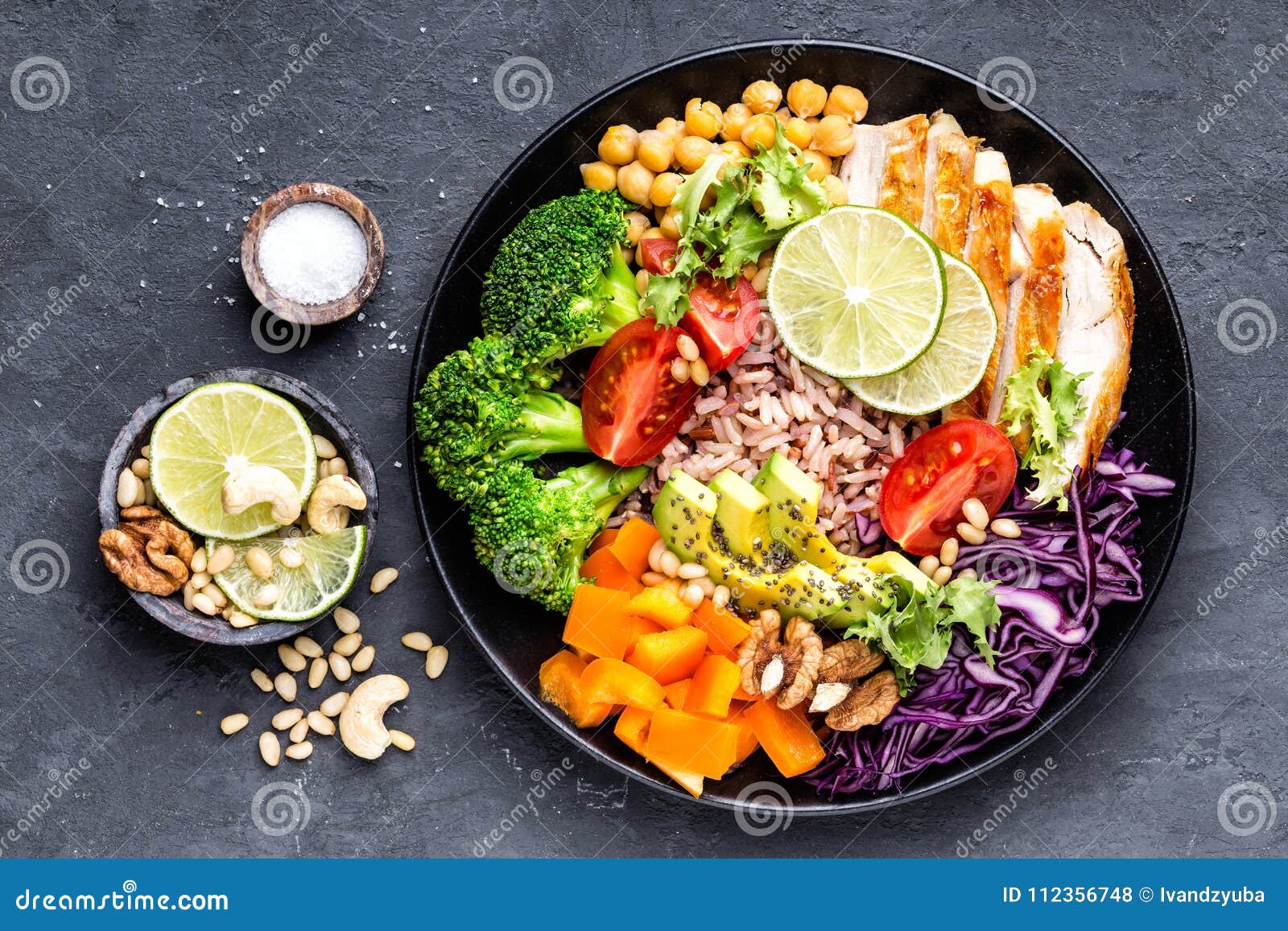 buddha bowl dish with chicken fillet, brown rice, avocado, pepper, tomato, broccoli, red cabbage, chickpea, fresh lettuce salad, p