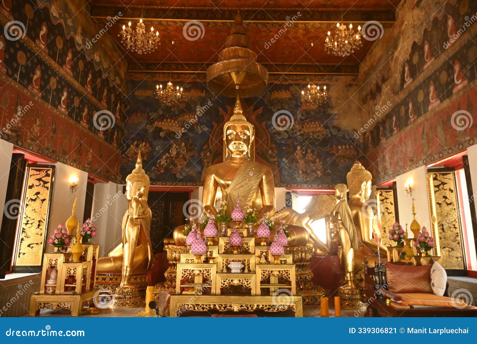 buddha image in the meditation posture is enshrined. surrounded by several buddha images.in the chapel at wat nang chi chotikaram.