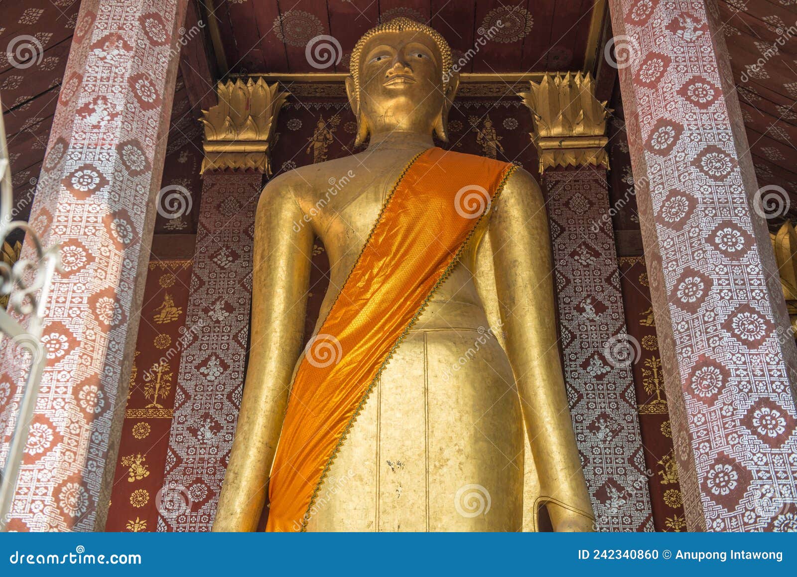 big standing buddha statue in wat sensoukaram, luang prabang, laos.